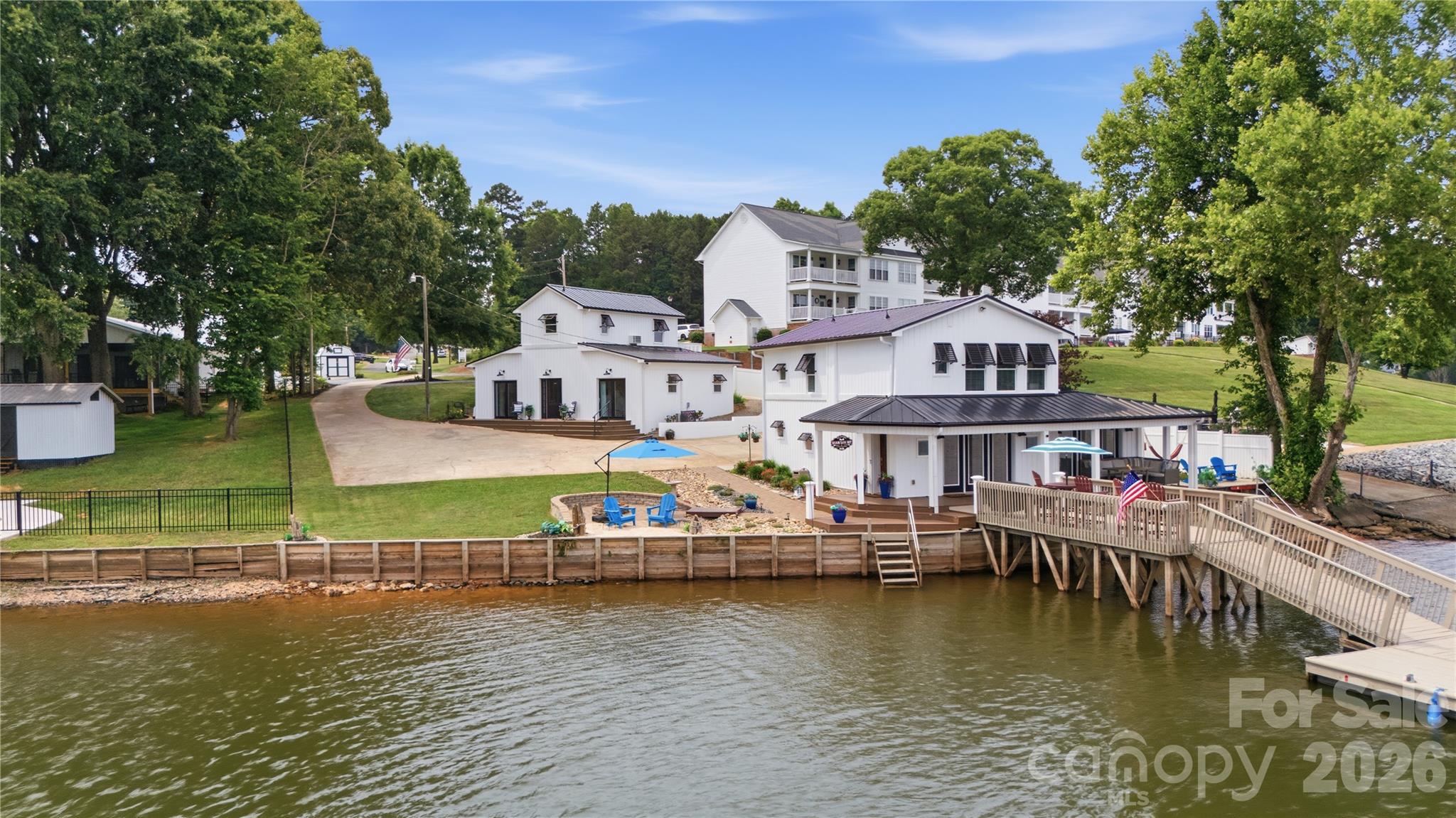 This High Rock Lake Waterfront TRIFECTA w/ long range lake views, beach area, & private dock, may come almost FULLY FURNISHED w/ an acceptable offer! Possibly 3 UNIT AirBNB potential? (1) beautifully renovated 2 bedroom home (just feet from the water) w/ a flex room w/ a murphy bed! (2) beautifully renovated studio (all one room) apartment above the... (3) beautifully renovated 2nd living quarters w/ a full kitchen & additional room! The 2nd living quarters & studio apartment has an ADDTL 1300+/- htd sq ft (not included in listed SF) & their private entrances offers flexibility for guests, family, friends, kids or home office use & so much more! Enjoy boating, fishing, kayaking, paddleboarding, or relaxing by the water. Also includes a 1/9 ownership interest in a nearby communal lot that may be used for watercraft storage and other shared recreational purposes. Conveniently located just minutes from NC Highway 8, marinas, restaurants, and local amenities. Pre-approved buyers welcome!