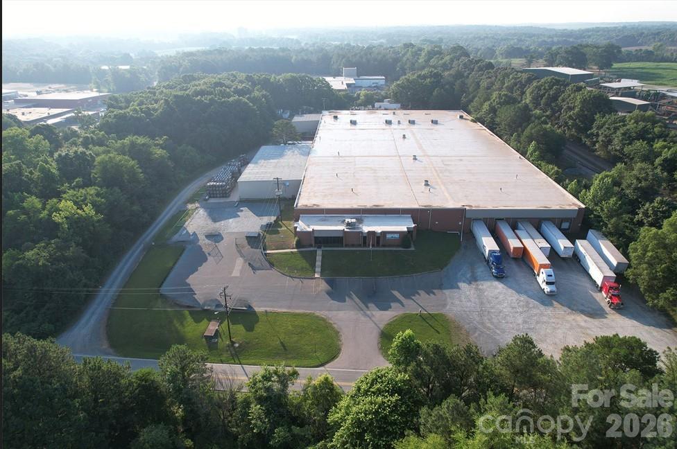 Industrial building with +/- 14.94 acres. Clear heights approx 14'-18'; 9 dock-high doors, 2 drive-in doors; approx 2,700 sf office area (2% office finish); current lease through February 2034 with one 5-year renewal option. Functional existing improvements with office buildout, maximizing manufacturing/warehouse efficiency; dual frontage on North Bivens Road and Stitt Street providing future redevelopment, expansion, yard storage, or subdivision potential; existing long term cash flow in place (modified NN lease) Large truck court and storage areas.