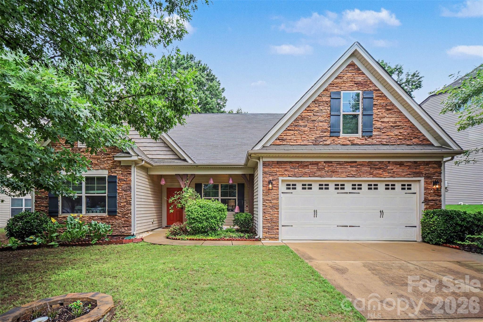 Beautifully maintained 1.5-story home tucked away on a quiet street in the desirable Riverwood community with private Lake Wylie access just at the end of the street! This home welcomes you with beautiful curb appeal with the primarily stone exterior and offers an open and functional layout inside with stunning hardwood floors throughout the main living areas, spacious living room with fireplace, and a large kitchen featuring granite countertops, center island, pantry, stainless appliances, and abundant cabinet space. Oversized main-level primary suite includes spacious walk-in closet and a luxurious bath with garden tub, dual sinks, and separate shower. Formal dining room with built-in buffet/bar area provides the perfect setup for entertaining. Upstairs offers an additional bedroom, full bath, and versatile loft/bonus space ideal for guests, office, or media room. Enjoy the fully fenced backyard with irrigation system and expansive patio for grilling and relaxation. Conveniently located near shopping, dining, I-485, Charlotte Douglas Airport, and outlet malls while still offering a peaceful neighborhood setting with lake access.