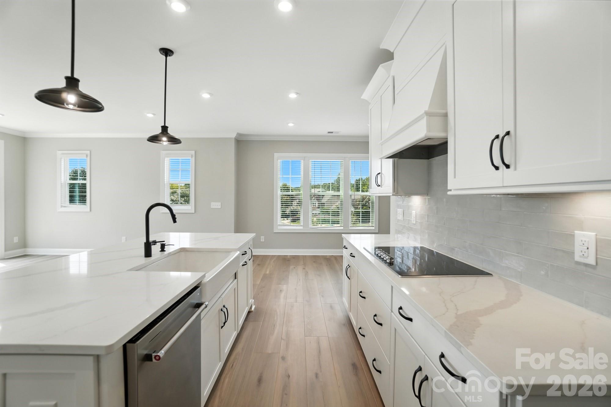 New Luxury Brick townhome in prime Ballantyne residential location! The Duke, a corner townhome filled with natural light from an abundance of windows on the South West and North West side, is one of 28 homes in our exclusive community!  Upon entering the elegant foyer, this home is designed with 2 Bedrooms on the first floor, one having direct access to the covered patio,  a large Bath featuring Dual Vanities, linen closet, and split bathroom and the Large Main Laundry Room.  On the opposite side of the foyer, entry to the oversized garage, coat closet and under stair storage.  The large open living area on the second floor features a stunning Gourmet Kitchen with Kitchen Aid appliances, 42" White cabinets w/soft close, pull out shelves, under cab. lights, Farmhouse sink, beautiful White Quartz countertops, ceramic Backsplash and a Large Walk In Pantry.  The deck off the Spacious Great Room extends the living area to enjoy the outdoors.  The 2nd floor, the Primary Bedroom is full of natural light and a huge Walk In Closet complete with a stacked Washer/Dryer gives you 2 Laundry locations in this home.  The 3rd floor Bedroom, a 2nd Primary features a sitting area, large bathroom with dual vanities and walk in closet.  Across the landing, Walk in Attic provides easy access to your HVAC and with plenty of extra room. This 4 bed/3.5 bath home is bright, spacious and beautifully appointed. The brick exteriors, 9 ft. ceilings with 8' doors on 1st and 2nd level along with upgraded LVP flooring, Crown Molding, molding around windows, 2" faux wood blinds throughout house and gourmet kitchen add value to this home in our exclusive community. 

Fabulous location only 1.5 miles from Blakeney Shopping Center, 4 miles to The Bowl at Ballantyne!

Incredible Financing Incentives available through our preferred lender.  Listed price includes all upgrades!.