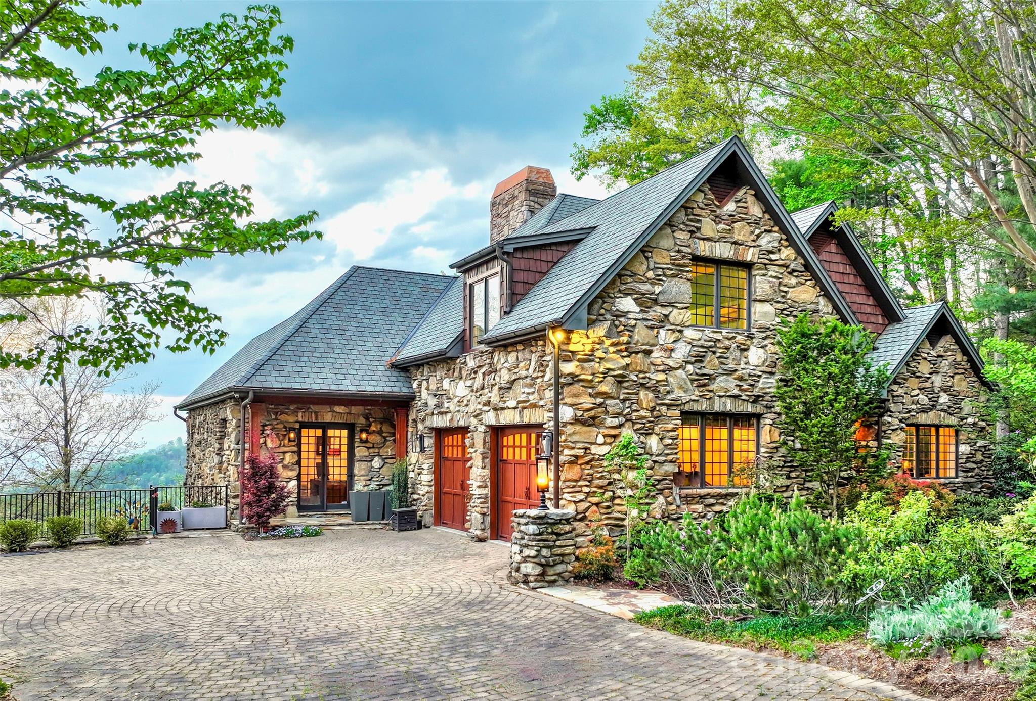 Do you want everything Asheville has to offer? Great long range mountain views, great location, great home, great neighborhood? Look no further! This wonderful and private Reynolds Mountain home has it all! Top-notch luxury construction with solid stone and beautiful curves. High-quality custom details. Exterior stonework modeled after The Grove Park Inn. Made for comfort and entertaining with two icemakers, three wine refrigerators, two tankless water heaters, and a built-in infrared grill on the covered porch. You couldn't build anything similar for anything close to this price. One level living as needed with room up and down for family, offices, guests, and activities. The house has been well cared for and was very nice when the sellers got it and yet they still managed to update and upgrade it. See attached list of improvements including adding a sauna.  By the way, they weren't planning to sell but life happens (they are moving to be close to grandkids). Come enjoy the ever-changing and always beautiful view without any scary steep roads or driveways! 15 minutes to Asheville, 10 minutes to Weaverville, 30 minutes to the airport. Check out the beautiful video!