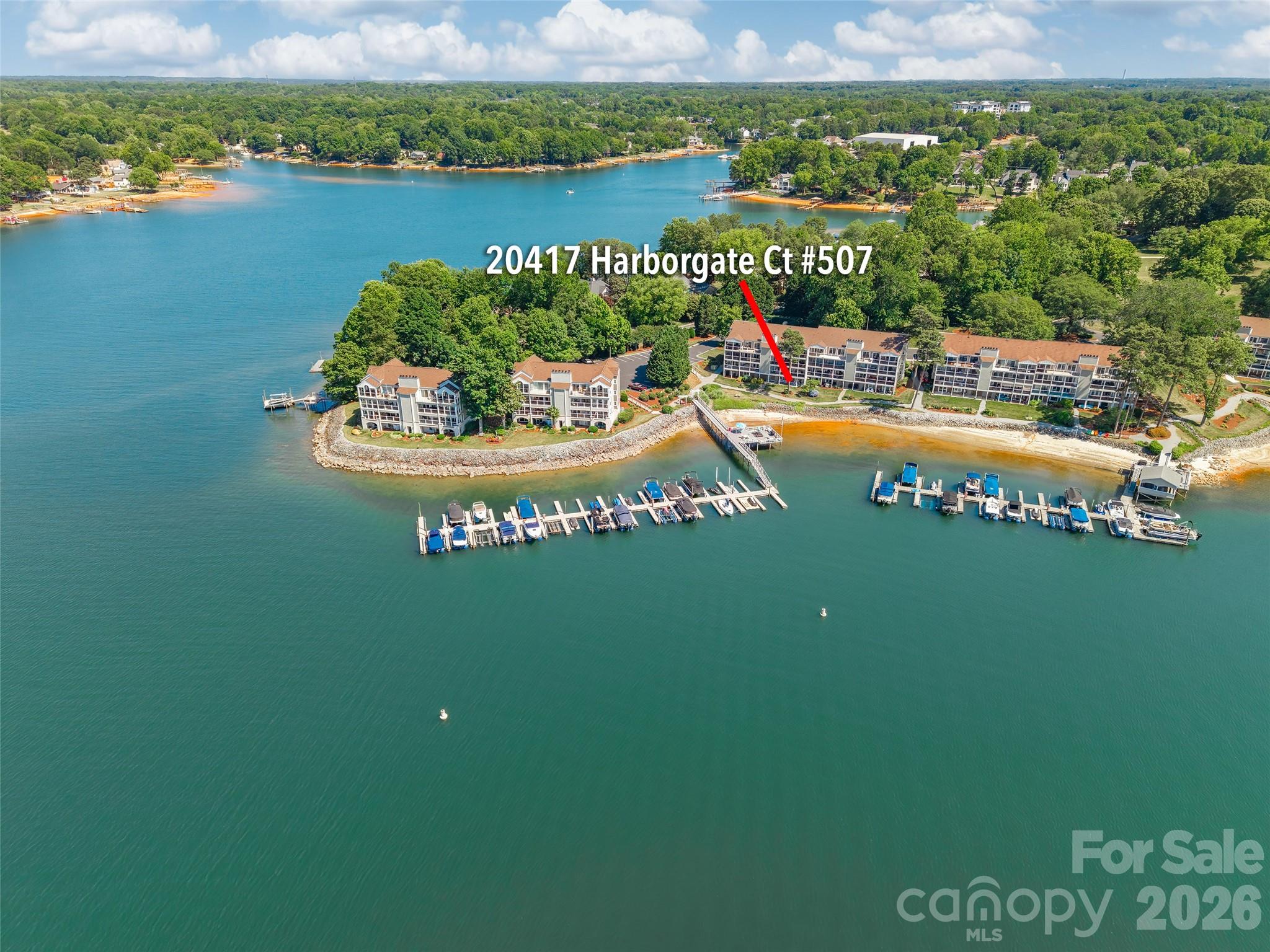 Residence #507 at Harborgate | Elevated Lake Norman Living 

Welcome to a rare waterfront offering where luxury, tranquility, and the ultimate staycation lifestyle converge. Perfectly positioned within the coveted Harborgate community, Residence #507 captures some of the most extraordinary unobstructed open-water views on Lake Norman, with breathtaking panoramic views stretching endlessly across the horizon.

This beautifully appointed two-story waterfront condo offers an elevated lakefront experience where every detail invites relaxation. From the moment you enter, the lake becomes the focal point. Sunlight dances across the water by day, while spectacular sunset skies create an unforgettable backdrop each evening. Whether enjoying morning vibes on the private balcony or an evening cruise from your deeded boat slip just steps away, every moment here feels like a retreat.

Featuring two bedrooms and two full baths, the residence showcases an open-concept layout curated to maximize the breathtaking lake views. The expansive lower level offers exceptional flexibility, ideal for an additional guest retreat, private office, fitness space, media lounge, or whatever your lifestyle and imagination inspire. From the lower lakeside patio, enjoy effortless access to your deeded boat slip, scenic walking trails, the private sandy beach, community docks, and kayak & paddleboard launch areas — all part of the peaceful, resort-inspired lifestyle Harborgate is known for. Whether spending the afternoon on the water, enjoying a sunset stroll along the shoreline, or simply unwinding in the serene waterfront setting, Residence #507 offers the perfect balance of luxury, relaxation, and everyday escape — all just minutes from Birkdale Village, upscale dining, boutique shopping, and convenient I-77 access. 

Waterfront residences within Harborgate offering this caliber of panoramic lake views combined with a deeded boat slip are exceptionally limited. Residence #507 is more than a home — it is a destination, a sanctuary, and a lifestyle designed to feel like vacation every single day.
