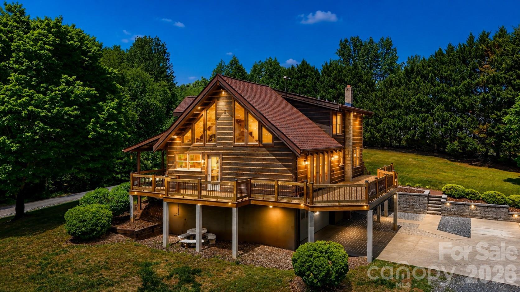 Nestled on 6.78 private acres, this charming 1996 log home offers the perfect blend of rustic character and comfortable living. Featuring three bedrooms and two full bathrooms, the home showcases a stunning two-story great room with cathedral ceilings, creating an open and inviting atmosphere. Warm all-wood flooring runs throughout, complemented by a cozy fireplace and wood-burning stove for added charm. The full basement includes a double garage, while an additional detached double garage provides ample storage and workspace. Enjoy peaceful surroundings and ultimate privacy in this beautiful countryside retreat.
