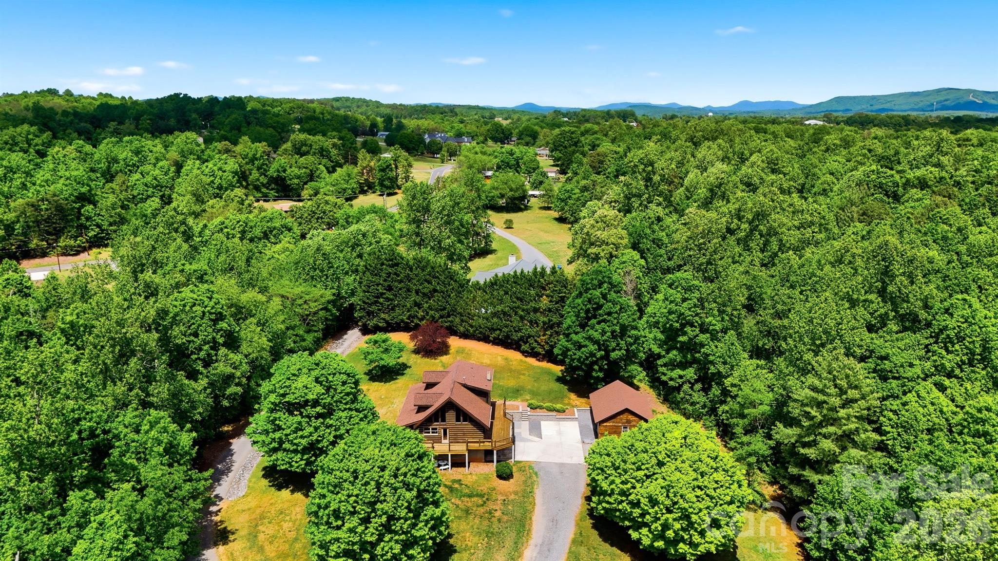 Are you looking for privacy? Nestled on 6.78 private acres, this charming 1996 log home offers the perfect blend of rustic character and comfortable living. Featuring three bedrooms and two full bathrooms, the home showcases a stunning two-story great room with cathedral ceilings, creating an open and inviting atmosphere. Warm all-wood flooring runs throughout, complemented by a cozy fireplace and wood-burning stove for added charm. The full basement includes a double garage, while an additional detached double garage provides ample storage and workspace. Enjoy peaceful surroundings and ultimate privacy in this beautiful countryside retreat.