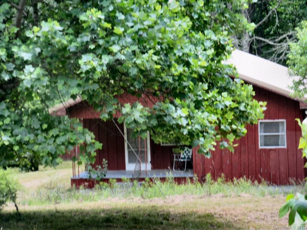 A three bedroom cabin with central heat!  Wood floors, this property can be used right away.  It has two out buildings.  One is quite large where you could hook up washer/dryer because building has a hot water heater, electric and water!  Sweet setting for this cabin with a creek and nice level property.  Paved driving all the way to this property.
This is  an appealing get away vacation property.