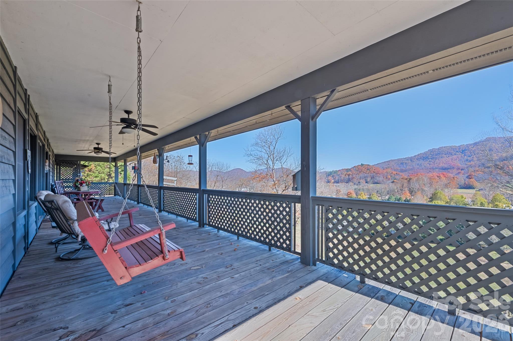 Wide-Open Mountain Views in Waynesville! Enjoy views from the covered deck and outdoor cooking area of this charming 2-bedroom, 2-bath home, built in 1993 and set in a peaceful country setting just 20 minutes from downtown Waynesville. This one-level home offers easy living, a spacious great room, a propane stove-style fireplace, a kitchen island, and large windows that fill the space with natural light and showcase the mountain scenery. Both bedrooms include private ensuite baths and walk-in closets. Step outside to the wraparound deck—perfect for relaxing or entertaining—with a covered outdoor cooking area ready for your grill and an outdoor portable gas fireplace. At 2,600+ ft elevation, this home enjoys cool mountain breezes and southeast-facing views ideal for sunsets. Additional features include ample parking for 2–3 cars, Zito internet/TV, city water, low annual HOA dues of just $120 (for road maintenance only). No city taxes and not within city limits. Short-term rentals are allowed.