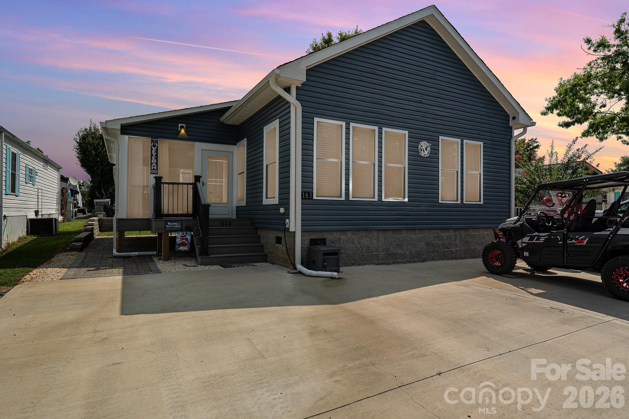 This beautifully furnished, single-level modular home, built in 2022, offers low-maintenance, year-round lake life at Badin Shores Resort, Badin Lake. Designed for easy living, the home features a spacious concrete parking area, screen porch with composite decking, and durable vinyl siding. Inside, enjoy an open-concept kitchen, living, and dining area, complemented by modern cabinetry, stainless steel appliances, and ample pantry space. Both bedrooms comfortably fit king-size beds, with the primary offering an ensuite bathroom for your private retreat. All furniture and kitchen essentials remain, making it move-in ready. The resort features 24-hour gated security, a seasonal pool, fishing pier, waterfront boardwalk, and more—perfect for an active, vibrant lifestyle!  24 hour notice to show required **Buyer has the first option to purchase the deeded 30ft boat slip at an additional cost.