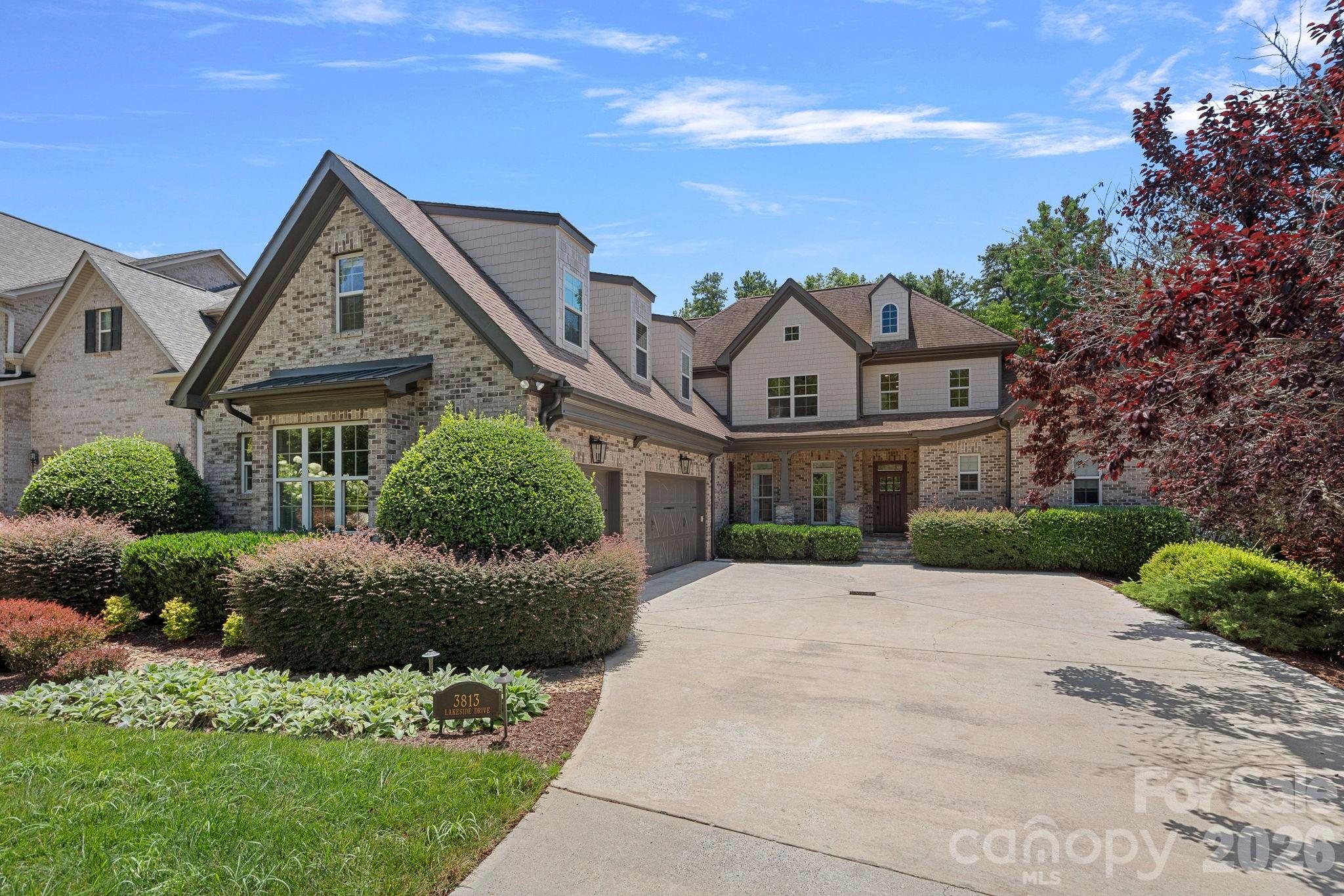 Tucked within an intimate enclave in the heart of South Charlotte, this exceptional custom residence is a masterclass in timeless architecture, impeccable craftsmanship, and effortless luxury. Cedar shingle accents, graceful dormers, and richly detailed millwork create an unforgettable first impression, while every space inside has been thoughtfully designed to balance grand entertaining with comfortable everyday living.

A soaring foyer introduces interiors defined by rich hardwood floors, extensive custom millwork, elegant wainscoting, and dramatic ceiling heights that fill the home with natural light and an unmistakable sense of scale. At the heart of the home, striking bifold wood doors dissolve the boundary between indoors and out, opening to an extraordinary screened porch that functions as a true extension of the living space.

The main level is anchored by a serene primary suite designed as a private retreat, while a second room—currently serving as a handsome home office with an adjacent full bath—offers the flexibility to function as a guest suite when needed. Every room has been carefully considered, creating spaces that are equally beautiful and highly functional.

Upstairs, two spacious ensuite bedrooms are joined by an expansive bonus room complete with its own bath and walk-in closet, easily serving as a media room, guest quarters, or an additional bedroom.

Designed for the way life is truly lived, the oversized three-car garage is complemented by a generous drop zone and an adjoining flex room ideal for a home gym, hobby space, climate-controlled storage, or future wine room.

The outdoor living experience is nothing short of exceptional. The expansive screened porch is appointed with radiant heaters, remote-controlled screens, and a drop-down projector and screen for unforgettable movie nights and year-round entertaining. Just beyond, a beautifully crafted stone fire pit creates the perfect gathering place beneath the Carolina sky.

This is a home where architecture, craftsmanship, and livability exist in perfect balance—thoughtfully designed for both elegant entertaining and quiet everyday moments. A rare offering that embodies timeless sophistication in one of South Charlotte's most coveted areas.