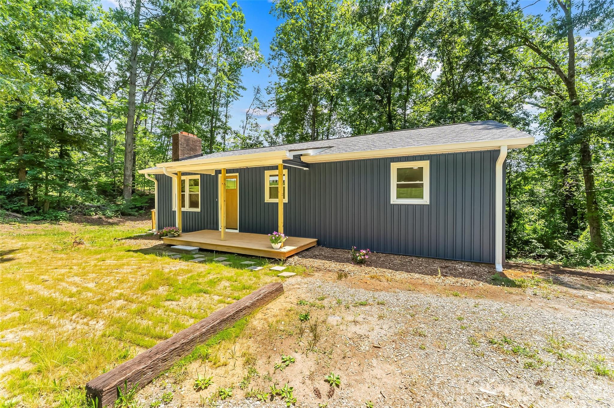 Welcome to this charming ranch-style home situated on a full acre in a peaceful setting that's just minutes from I-40, shopping, restaurants, and everyday conveniences. As you pull in, the inviting curb appeal immediately stands out with its covered front porch, brand-new side deck, and modern farmhouse-inspired character. Whether you're enjoying your morning coffee or hosting family and friends, the outdoor spaces offer the perfect place to relax and unwind. With two driveways, there's plenty of room for guests, recreational vehicles, trailers, or additional parking. Inside, you are welcomed by a bright interior where new windows fill the home with natural light. The spacious living area centers around a beautiful wood-burning fireplace, creating the perfect gathering space for cozy evenings at home. The kitchen has been thoughtfully designed with quartz countertops, a farmhouse sink, and abundant cabinetry, blending style and functionality. Throughout the home, you'll find updated LVP flooring, fresh paint, and ample storage, all contributing to a comfortable and inviting atmosphere. The lower level offers even more flexibility with a one-car garage and two additional rooms that could easily serve as a workshop, home gym, hobby space, office, or extra storage. Outside, the full-acre lot provides plenty of room to enjoy the outdoors while still being conveniently located near everything you need. With improvements including new vinyl siding, a 2022 roof, and a new HVAC system, this home offers the perfect combination of charm, comfort, and peace of mind.