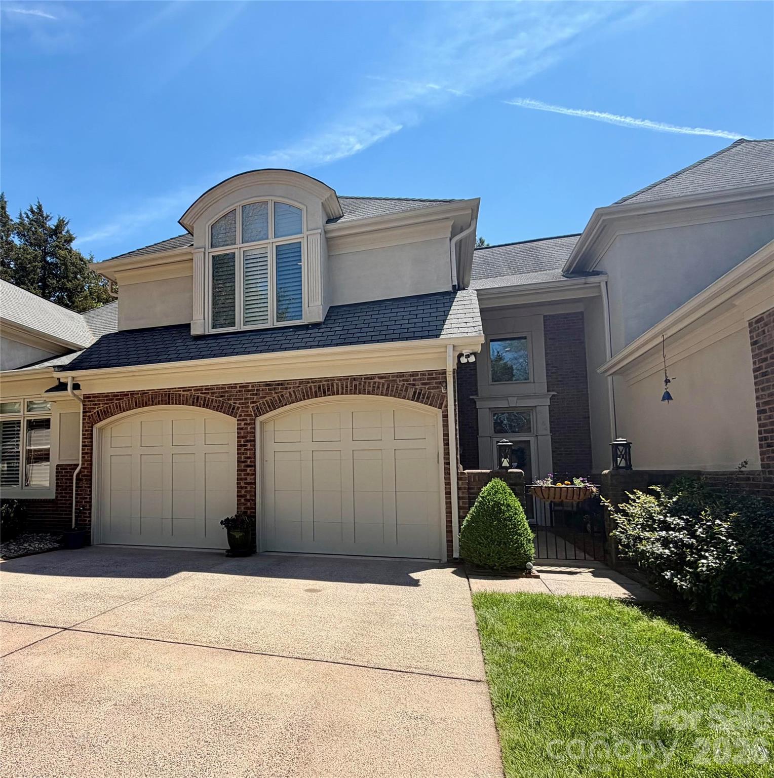 Significant Price Reduction and Prime Location - Take advantage of this unique opportunity to own a beautifully appointed, spacious townhome in the highly sought-after Challis Hill Townhome community. This light-filled home features an open, inviting layout perfect for both everyday living and entertaining. The kitchen shines with crisp white cabinetry, granite countertops, classic subway tile backsplash, and stainless steel appliances. Relax year-round in the bright sunroom, which opens to a raised patio overlooking a private, landscaped courtyard—an ideal space for morning coffee or evening gatherings. A unique bonus: the property line extends approximately 30 feet beyond the brick wall, offering added outdoor flexibility and value. This home showcases architectural details throughout adding character and charm—including a loft/study with custom built-in bookcases. The primary suite impresses with a soaring ceiling, cozy window seat, and abundant natural light. Enjoy plantation shutters, updated lighting, and a fresh neutral palette throughout. The updated primary bath features a large walk-in shower with frameless glass door, plus a relaxing garden tub. The primary suite includes a dressing area with an additional vanity seat and large 6' x 10' walk-in closet. Thoughtful updates add even more value and peace of mind, including a brand new dishwasher (2026), a newer kitchen refrigerator (2025), and a whole-house water filtration system for enhanced comfort and quality throughout the home. Additional highlights include ample storage in all closets as well as a concrete pad crawl space for extra storage space. This is a rare blend of style, space, and location—don’t miss your chance to call it home.