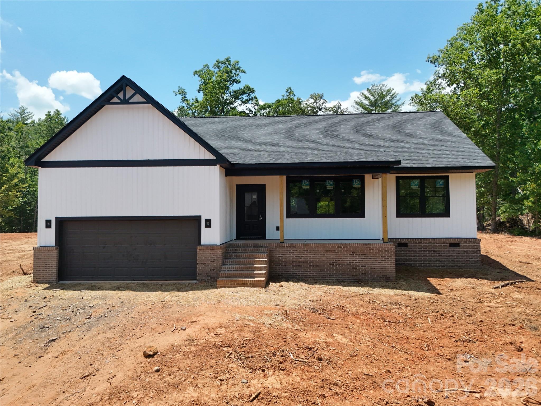 Welcome to a custom built home that delivers the kind of quality, layout, and finish level buyers immediately notice the moment they walk through the door. Offering 3 bedrooms, 2 bathrooms, and 1,827 heated square feet, this home sits on a spacious .57 acre lot that provides the breathing room and privacy today’s buyers are looking for.

Built with a cohesive vision and attention to detail throughout, this is not your typical cookie cutter construction. Every home in the community is thoughtfully designed to create a clean, elevated streetscape with consistency in quality and appearance from beginning to end.

The exterior makes a strong first impression with a beautiful brick veneer front elevation, modern lines, black windows, and a bold, upscale presence. Inside, you will find 12mm luxury vinyl plank flooring throughout, installed over an Advantech quiet subfloor system that creates a noticeably solid and durable feel underfoot.

The kitchen was designed to be both functional and visually striking, featuring quartz countertops, soft close cabinetry, and black accent finishes that tie seamlessly into the lighting and fixtures carried throughout the home. The open concept layout creates effortless flow between the kitchen, dining, and living spaces, making the home ideal for everyday living and entertaining alike.

The primary suite offers a spacious bedroom layout along with a large walk in closet that provides ample storage and functionality without sacrificing comfort. Energy efficient Jeld Wen windows and sliding doors allow natural light to pour into the home while maintaining comfort and efficiency year round.

Step outside to a covered concrete patio overlooking the backyard, creating the perfect space to relax, entertain, or simply enjoy the added privacy your lot provides. A full 2 car garage completes the home with the functionality and storage space every homeowner needs.

***ETA on Completion Date is 07/24 and Professional pictures will be taken on 07/25 and updated***

This home represents the next step in something bigger. It is one of the early releases in the Rodger’s Estates Subdivision, a 44 home community where every home is custom built with a unified design standard and attention to detail throughout. This is home number 6 of 44, and the momentum is just getting started.