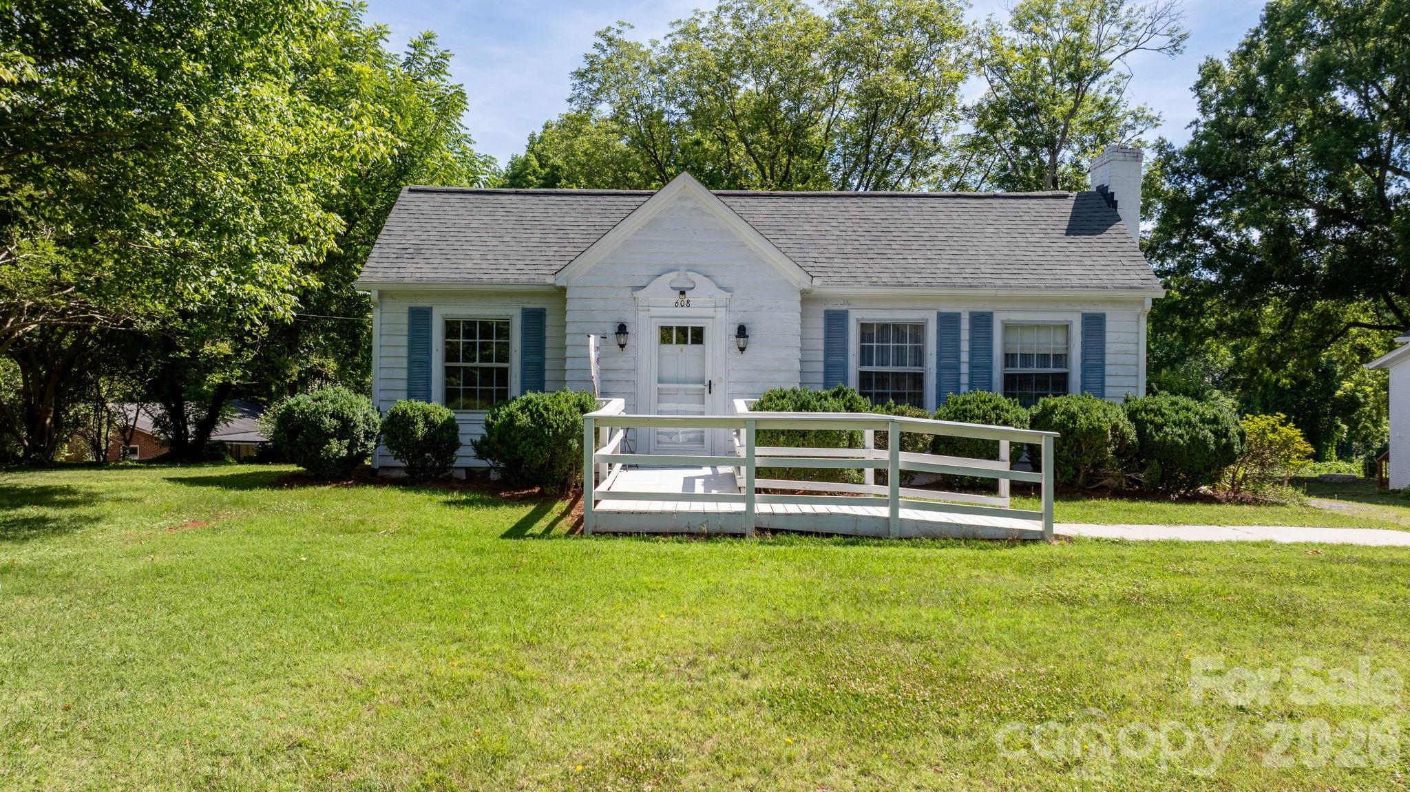 Welcome home to this inviting 3-bedroom, 2-bath wood-clad bungalow that exudes 1940s charm, complete with a cellar foundation, separate dining room and large living room with a fireplace. The unheated sunroom features broken brick flooring and vinyl replacement windows. The den boasts beautiful solid wood built-ins and custom wooden cornice boards, while the original solid wood kitchen cabinets remain in excellent condition with ample storage. Both full baths feature well-kept ceramic tile. A double detached garage offers additional upstairs storage. Priced for great value, this well-maintained property is zoned B-2, perfect for either residential or business use.