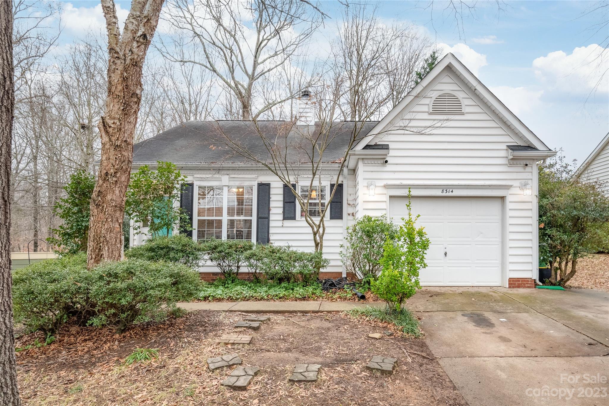 Welcome to affordable living in Charlotte!!  This home has the ease of one level living.  Kitchen has a great backsplash and stainless steel appliances.  Chair rails in much of the home add character while the absence of carpeting makes this home ideal for those who prefer easy cleaning!  Enjoy the ambiance of the wood burning fireplace.  The home features three bedrooms, two full baths and a covered porch for grilling on rainy days.  Enjoy the large backyard with plenty of trees for shade and natural views.  Refrigerator, washer and dryer convey.  Perfect starter home or ideal for investors.  Please note that this home is being sold As Is and it is priced as such.  The gutters have guards to keep them clear of leaves and the crawlspace is waterproofed.  Showings begin Sunday, 1/21.