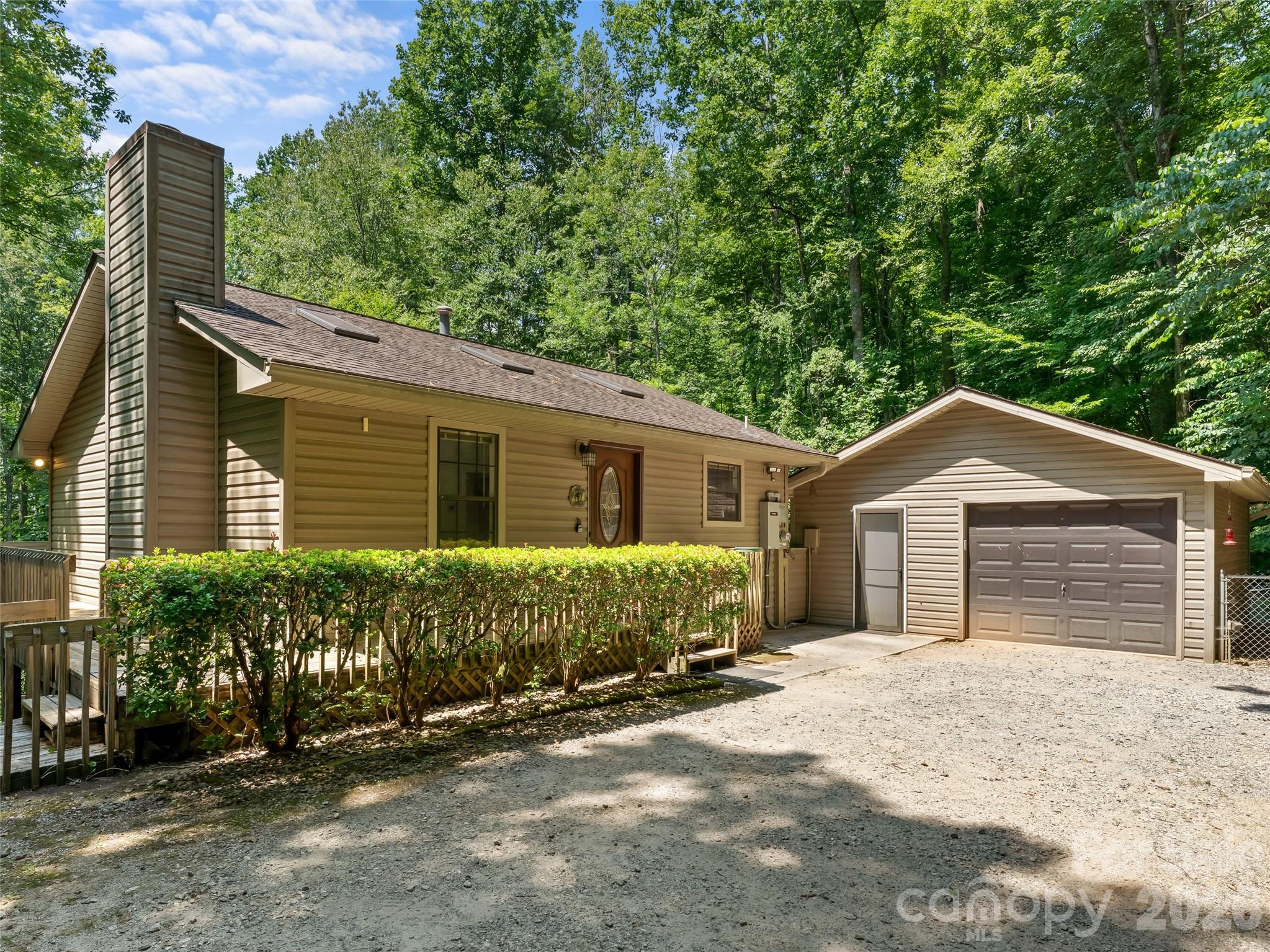 Prime Brevard Location with Privacy and Modern Comfort. This home is in a Top-notch location just outside the city limits of Brevard. This property offers the conveniences of city water and city sewer without having to pay city taxes. Situated on a beautiful private wooded lot, this home offers a peaceful setting while still being close to all that Brevard has to offer.

The inviting interior features vaulted ceilings and a cozy gas fireplace that creates a warm and welcoming atmosphere. The primary bedroom is located on the main level and includes a spacious walk-in closet for added convenience. The lower level provides additional living space with a bonus room, full bath, and second bedroom, offering flexibility for guests, an office, or recreation space.

Additional highlights include a natural gas Generac backup generator for peace of mind, a fenced in back yard and a one-car detached garage with room for storage. With 2 bedrooms, 2 full baths, a private wooded lot, and the convenience of city utilities, this home is a wonderful opportunity to enjoy comfortable living just outside Brevard.