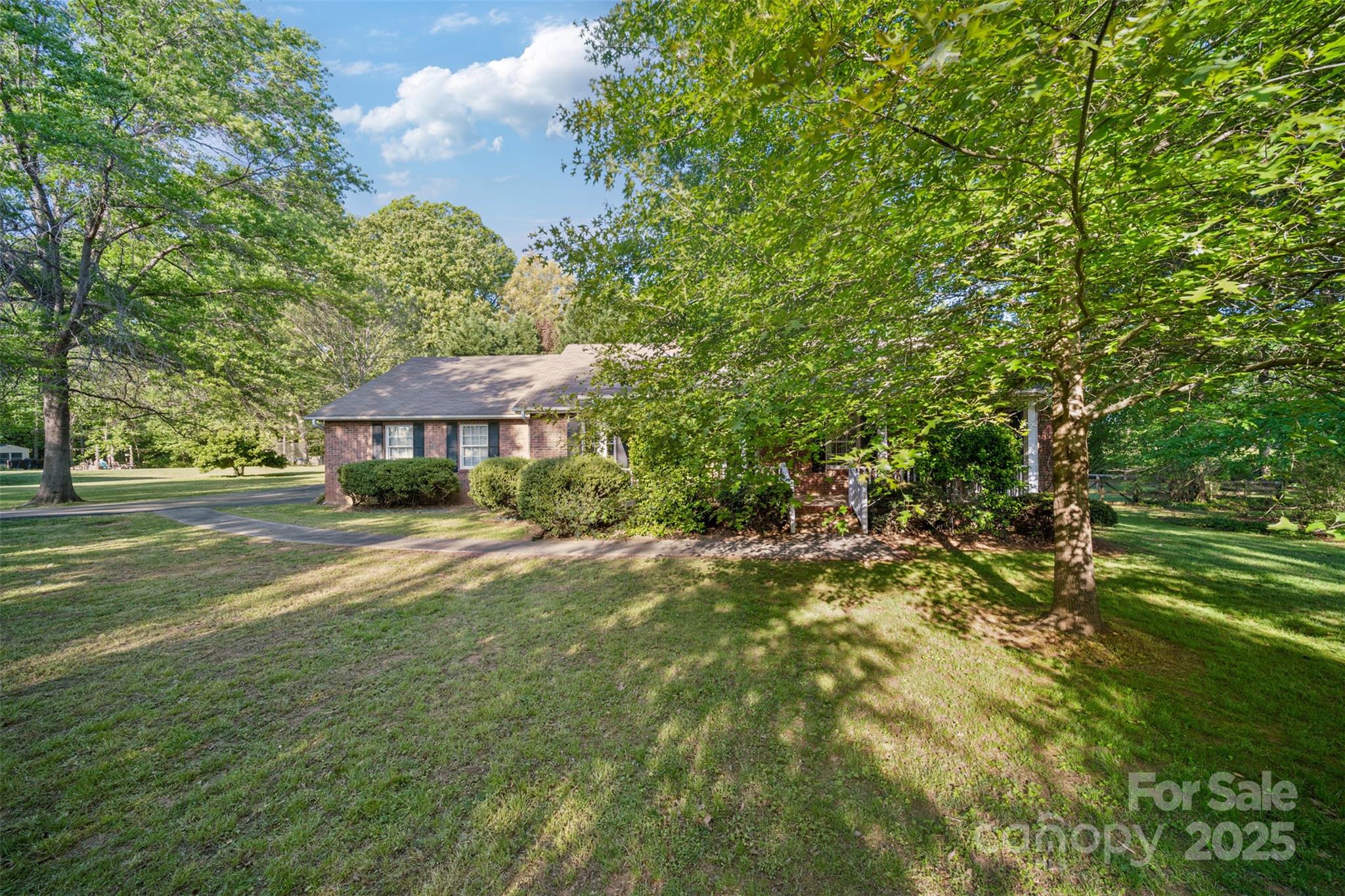 Stunning single-story brick home on a private 1-acre lot.  Features an open layout with a spacious Living Room, complete with a fireplace, flowing into the Dining Room. The expansive kitchen boasts ample cabinetry, electric stove, dishwasher, microwave and a cozy breakfast nook. The Primary Suite includes a walk-in closet and a bathroom featuring a walk-in shower. A secondary bedroom offers a private bath. Enjoy a large utility room with a laundry closet, half bath, and generous pantry. The oversized 2-car garage provides extra storage, complemented by a screened-in porch, deck, and charming front porch perfect for rocking chairs.