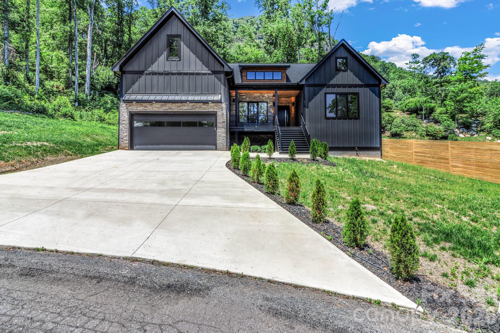 Discover this stunning 2,750 sq ft new construction home just 10 minutes from downtown Asheville. This thoughtfully designed home offers 3 bedrooms and 2.5 bathrooms and a laundry room on the main level, with a bonus room and full bath upstairs—perfect for guests or a private suite. Gorgeous real hardwood floors throughout, 10-foot ceilings, and real tile in every bathroom. The spacious kitchen features a large island, quartz countertops, gas stove, and a cozy gas fireplace in the living area. The main level also includes a dedicated office, ideal for remote work or creative space. An additional 1,000 sq ft of unfinished attic space offers future potential. Step outside to a peaceful backyard with a recently installed wooden fence for added privacy as you sit around the fire pit and enjoy the close-range mountain views.  A perfect blend of modern finishes and natural beauty, this home offers the best of Western North Carolina living. Don’t miss the opportunity to own a quality-built home in a prime location.