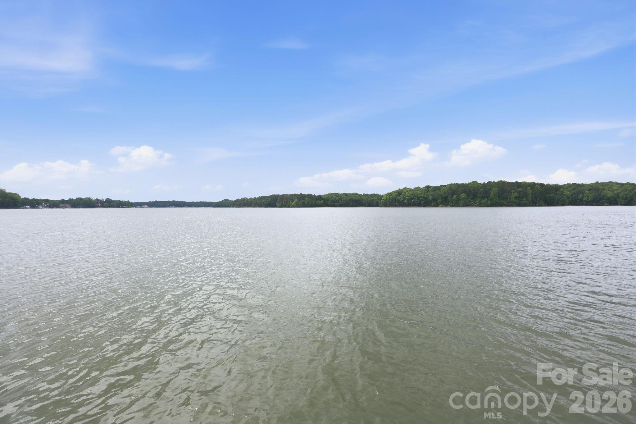 Experience unparalleled lakeside luxury in a meticulously reimagined waterfront  home in a prime location in sought after Anchor Downs. Renovated entirely to the studs, this pristine 3 level residence offers a rare blend of sophisticated design cutting-edge technology.
The 3,500 + square foot smart home is the complete lake front package. From its gourmet kitchen with custom cabinets and Venaska granite and Kalista faucets. The large work island is crowned by a schonbek crystal chandelier and walk in pantry. Top of the line stainless steel appliance. Eat in or lounge area. Great room with vaulted ceilings, exposed beams and unique stone fireplace. 
Upper level consists of a primary bedroom with stunning lake views. Glamorous bathroom with separate vanities, stone shower and private water closet. Large walk-in closet, elevator access, laundry room and gym complete the upper level.
Lower level will not disappoint with second kitchen, great room with stone fireplace, two guest bedrooms, full bathroom and second laundry room.
This home will work for a multi-generational family. Two car garage, screened in porch, deck, covered patio and outdoor shower. Whole house generator. New pier and floater. Private boat ramp. 147 feet of water frontage. 
No expense was spared in making this home retreat absolutely remarkable!  This home and property offers the discriminate buyer a rare opportunity to live the ultimate lake lifestyle.