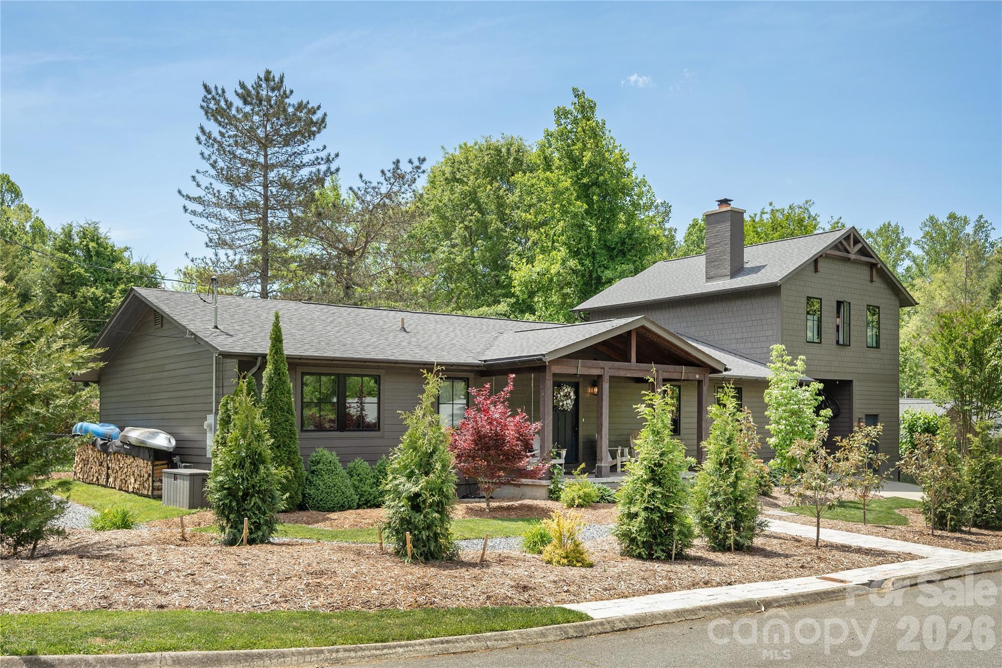 Tucked away on a quiet street in desirable Downtown Brevard, this fully renovated Modern American Craftsman Home is the definition of mountain town living. Walk to shops, restaurants, cafes, parks, everything! Every surface of this home has been meticulously renovated and cared for. The main level is thoughtfully designed for living well and entertaining, and features a spacious chef’s kitchen with premium-grade appliances, tons of cabinets, farmhouse sink and a stunning calacatta dior marble kitchen island. The living and dining areas feature a wood burning fireplace, custom built-ins and beautiful oversized windows. Large glass doors lead you onto a lovely blue stone back porch, fenced in backyard with pristine landscaping and a vegetable garden. Main level also features three oversized bedrooms, two full bathrooms, a gorgeous laundry room with additional creative space, and a well appointed drop zone with a wall of cabinets equipped with individual charging stations. Upstairs you will find the newly built primary bedroom suite. This restful space offers winter ridgeline views, a premium en-suite bathroom with shower and soaking tub, walk-in closet, built-in desk, sitting area and fantastic natural light. This home has a carport with lots of space for your toys and an attached fitness and storage room. Additional features include: new aluminum clad/wood windows, new solid wood exterior doors, ample interior storage, an abundance of natural light, wide stair hall, a classic and welcoming front porch, fully landscaped and low maintenance yard featuring evergreen privacy screens, new gutters and underground drainage. Come see!
