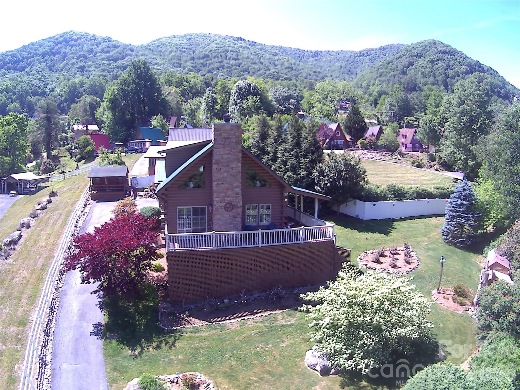 A beautiful well-maintained log cabin located just minutes from downtown Maggie Valley, Cataloochee, and Cherokee, offering stunning, unobstructed mountains views, a large covered and uncovered porch, easy and paved access. It provides a truly cozy retreat where you can enjoy absolute tranquility, featuring a lovely garden and exquisite finishes. The property includes a master bedroom as well as a loft—currently utilized as a second bedroom—completed with its own private bathroom. Additionally, it features a detached two cars garage and a detached workshop, from which you can also admire the mountain scenery and occasionally spot deer and elks.
For appointments, please allow at least 2 hours before showing, house is owner occupied. City water (City of Maggie Valley), septic, Electricity, Haywood Electric; septic tank was cleaned in May 2026. Motivated sellers.