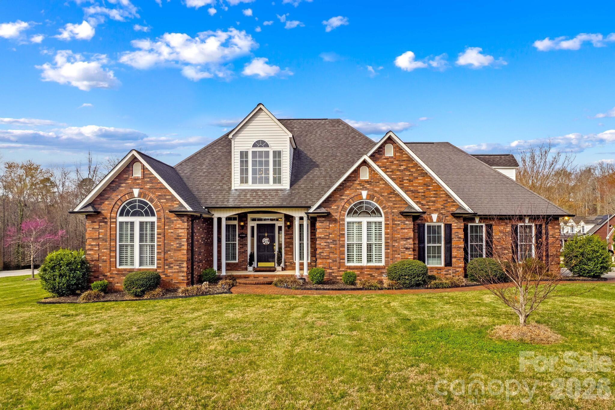 Welcome home to this beautifully designed 1-story home with FROG offering 2,404 sq ft, 3 bedrooms, and 2 baths, perfectly situated on a spacious ½-acre corner lot with easy access to I-85, making commuting to nearby cities simple and convenient.

Step inside to a beautiful open floor plan featuring a welcoming foyer that leads into a grand living room with cathedral ceilings, custom built-ins, and elegant plantation shutters. French doors open to a 453 sq ft deck, creating the perfect space for outdoor entertaining.

The living area flows seamlessly into the spacious kitchen, complete with granite countertops, custom wood cabinetry with accent lighting, and glass-front cabinets ideal for displaying dishes. A cozy breakfast nook adds warmth and charm, while the elegant dining room with cathedral ceiling provides a stunning setting for gatherings. Large windows with plantation shutters allow abundant natural light throughout the home.

The main level features exquisite hardwood flooring throughout with tile in the bathrooms. The primary suite offers a private deck entrance, two walk-in closets, and a completely remodeled spa-like bathroom featuring a soaking tub, tiled walk-in shower, beautiful cabinetry with quartz countertops, and outstanding lighting.

Secondary bedrooms are generously sized, and the hall bath has been tastefully updated with tile accents and quartz countertops.

The oversized FROG/bonus space offers incredible flexibility—perfect for an additional bedroom, office, playroom, or media room.

Car enthusiasts or hobbyists will appreciate the 2-car attached garage plus a separate 1-car detached garage that includes water service and a loft area with additional space that could easily be finished for extra living space, workshop, or studio.

With space, style, and convenience, this home offers the perfect blend of comfort and functionality both inside and out.
