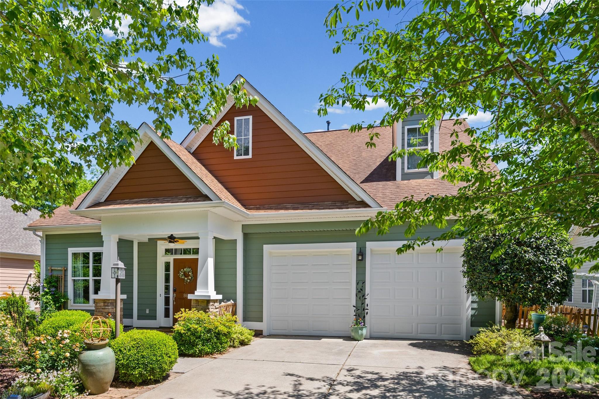 Welcome to this beautifully appointed home in the heart of coveted Fort Mill, ideally situated at the end of a quiet cul-de-sac and backing to serene wooded views. Offering the perfect blend of comfort, craftsmanship, and functionality, this home is designed to meet a variety of lifestyle needs.

Step inside to a grand entry foyer featuring a built-in backpack station and dedicated shoe closet, creating an organized and welcoming first impression. Just off the foyer, a versatile flex space with double French doors is perfect for a home office, sitting room, or playroom.

The spacious owner’s suite is conveniently located on the main level and includes a private sitting area, creating a true retreat. The en-suite bath boasts dual oversized walk-in closets, a large linen closet, a garden tub, and a frameless glass shower. A secondary bathroom upstairs features a custom walk-in frameless shower and double vanity.

Throughout the home, you’ll find extensive crown molding, detailed woodwork, and custom craftsman-style lighting that elevate every room. The main living area is anchored by a cozy gas fireplace, while hardwood and tile flooring span the entire first floor.

The well-equipped laundry room includes a utility sink and a full wall of cabinetry for added storage. Upstairs, you'll find three generously sized bedrooms, a spacious den, and an additional flex area with sliding doors—ideal for a fifth bedroom, guest suite, office, or wellness space. All upstairs flooring is hardwood, and every window is fitted with blinds.

Storage is abundant, including two large attic spaces (160 sq ft and 120 sq ft), each with separate access doors and exhaust fans. Additional highlights include a large two-car garage and oversized closets throughout.

Enjoy outdoor living year-round on the fully tiled, screened-in back porch and adjoining patio overlooking a private, fenced backyard with mature landscaping and a 13-zone irrigation system.

This home comes fully loaded with appliances, including washer, dryer, stove, new dishwasher, microwave, new refrigerator, plus an additional fridge and freezer in the garage. Extras such as a 65” 4K Samsung TV, unused wood flooring, and a large leather couch upstairs are also included.

Community features are equally impressive, with a scenic wooded path (currently being upgraded) leading to a gazebo grilling area and connecting to town trails. Enjoy easy access to local parks, festivals, and the nearby amphitheater, as well as shops and dining.

Major updates include a roof with Owens Corning architectural shingles (2014), a new Bradford White hot water heater (2024), and well-maintained HVAC systems with documented service history.

This exceptional home offers space, flexibility, and premium features—all in a peaceful, highly desirable setting.