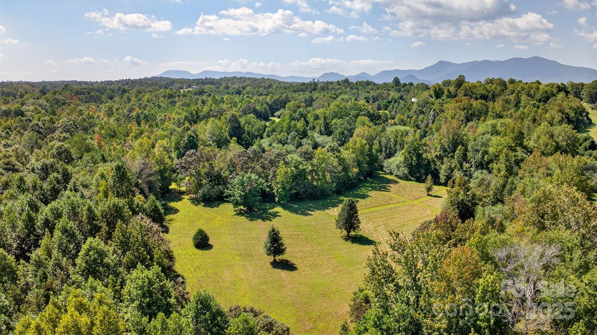 Discover the perfect blend of open pastureland and wooded privacy on this 17.18-acre property located in Tryon, with convenient access to Asheville, NC, and Greenville, SC. Offering 8.95 acres of cleared pasture ready land and 8.23 acres of mature forest, this property provides endless opportunities for building, farming, or recreation.

Set along a privately maintained road with county road frontage, this land is enhanced by a well and septic system already installed, saving you time and expense when planning your future home or development. With no HOA or restrictive covenants (CCRs) and many quality building sites, you’ll enjoy the freedom to use the property as you choose.

The landscape is both beautiful and versatile with a network of manicured trails throughout the property, featuring gently rolling elevation a peaceful creek front, and the potential for sweeping mountain views in the distance. The cleared acreage is ideal for cattle, horses, orchards, or agricultural projects, while the wooded areas provide natural seclusion, shade, and abundant wildlife. Whether your vision is an equestrian estate, small farm, family homestead, or investment opportunity, this land offers a rare combination of flexibility and natural beauty.

Located in desirable Tryon and just minuted from the International Equestrian Center, the property places you within minutes of local conveniences, yet close enough to enjoy the vibrant culture, dining, and amenities of both Asheville and Greenville. This is a unique chance to own acreage that supports both lifestyle and investment potential.

Property Highlights:
 • 17.18 total acres (8.95 cleared pasture / 8.23 wooded)
 • Existing well and septic
 • No HOA, no CCRs
 • Creek frontage with rolling topography (1,000–1,500 ft elevation)
 • County road frontage & privately maintained road access
 • Suitable for agriculture, cattle, horses, orchards, or residential development
 • Minutes to Tryon; convenient to Asheville and Greenville

Don’t miss this opportunity to create your dream lifestyle on a property that offers privacy, freedom, and potential in one of the Carolinas’ most sought-after locations.