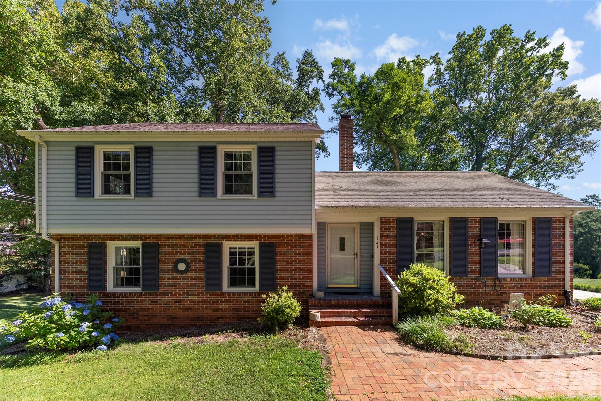 Rare opportunity to own a property with two included lots in the heart of Fort Mill. Nestled among mature trees and overlooking a peaceful creek, this 4-bedroom split-level home offers a setting that feels tucked away while remaining just minutes from downtown Fort Mill, local dining, shopping, and everyday conveniences.

Inside, you’ll find approximately 1,700 square feet of living space, multiple gathering areas, and a gas-log fireplace that adds warmth and character to the home. The kitchen is equipped with a gas range, gas cooktop, refrigerator, and dishwasher, while the flexible floor plan provides space for a variety of lifestyles and needs.

Step outside and enjoy the natural surroundings from the front porch, gather around the fire pit, or relax in the gazebo overlooking the wooded landscape. An outbuilding provides additional storage or workspace options. The sale includes a second parcel, creating a combined homesite of approximately 0.59 acres and offering added space, privacy, and future possibilities.

Properties offering this combination of land, location, and natural beauty within Fort Mill town limits are becoming increasingly difficult to find.