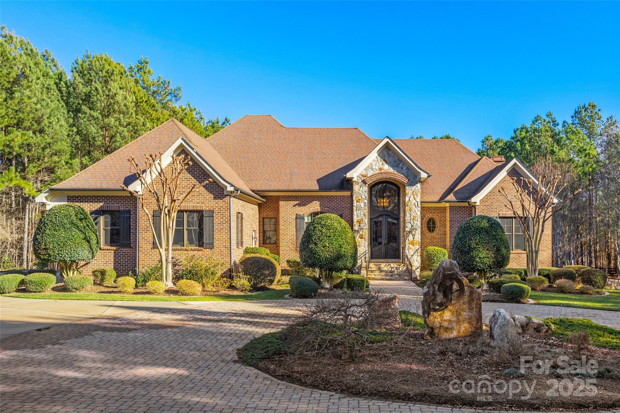 Luxury Ranch Estate in Olde York Farms – A True Masterpiece where luxury meets serene country living. This custom-built Ruth Builders ranch home sits on 6.5 fully fenced and manicured acres, just 5 minutes from downtown York and 30 minutes to Charlotte. This 4-bedroom, 5-bathroom gem boasts high-end features at every turn. The main-level primary suite offers a spa-like retreat with a walk-through shower, heated marble floors, and luxurious finishes. A second primary suite downstairs with its own kitchen and entertaining area makes for the perfect in-law suite. The chef’s kitchen dazzles with Dacor appliances, a SubZero refrigerator, pot filler, and much more.
Enjoy a Movie Theater, Wine-tasting Room, Grand Home Office, Elevator, and even a Hidden Vault! Outdoors living at its finest with a saltwater pool & spa, upper terrace, dining / living spaces, fire pit and more. Large 4-car garage, lower level ATV garage, and stunning brick paver driveway, this home truly has it all.