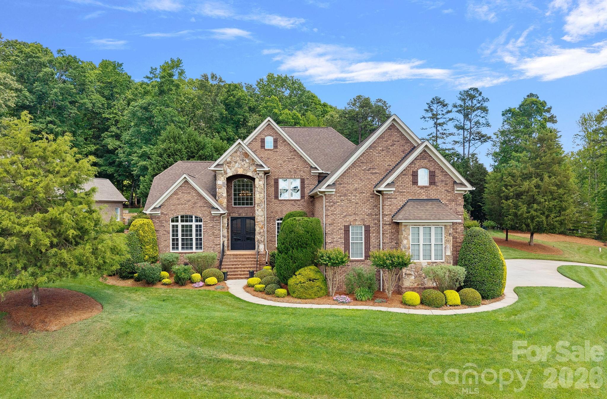 Gorgeous Custom-built Home in the sought after Anniston, located 4-5 miles from downtown Davidson. This meticulously maintained Home is situated on a choice, Estate size lot, on a small cul de sac. Private setting and fully fenced property, with lush landscaping, and resort style outdoor living. Beautiful Pool with Spa & Waterfall, large, covered patio with gas log Fireplace and well equipped outdoor Kitchen. 24k whole house Generator! Stunning, newly installed iron doors graciously welcome you into the grand two-story entry. The main floor boasts an open floor plan for effortless entertaining. Large great room with stone surrounding the linear gas fireplace. Gourmet kitchen offers large island, extensive countertops, electric cooktop with grill, warming drawer, large microwave and oven. Coffee/liquor bar for entertaining provides additional storage. Office with vaulted ceiling and plantation shutters, formal dining room with molding/butler’s pantry & plantation shutters. The oversized primary suite with large sitting area opens to the covered patio. Slate tile adorns the primary bath/jetted tub & large, multi-head shower walls, offering bench seating. Large custom closet. Solid wood flooring in the most common areas. Dual staircase to spacious upper lever, with 3 guest bedrooms - one is currently being used as a flex space with office. Upper bathrooms have been updated to modern finishes. Large bonus room with electric shades overlooks backyard. Closet has electronics for TV/sound/camera systems. Large storage closet, and several walk in attic storage areas with additional insulation. Davidson location with low Iredell County taxes!  Come experience a new way to live!