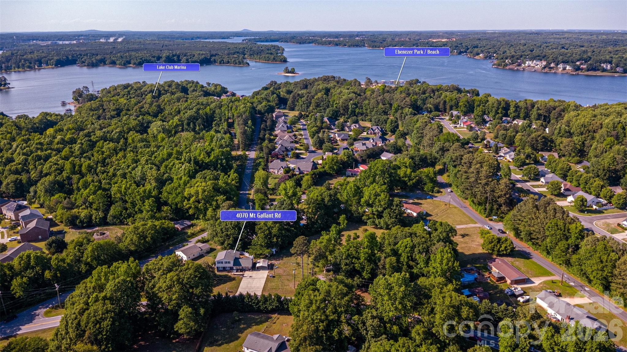 Rare find in Rock Hill—over 2 acres, a massive powered workshop, walkable Lake Wylie access, and potential future commercial opportunity.

Imagine being able to walk or take a quick golf cart ride to Lake Wylie whenever you want—whether it's a morning walk through Ebenezer Park, a sunset by the water, or launching the boat from nearby Lake Club Marina. This is the kind of lifestyle that makes this property truly special—and increasingly difficult to find.

Set on a beautifully positioned corner lot with a mature magnolia tree, this property offers the perfect blend of space, flexibility, and convenience. Inside, you'll find more than 2,600 square feet featuring a spacious family room, abundant natural light, a stunning picture window overlooking the property, and a cozy wood-burning fireplace with rebuilt firebox. The flexible floorplan includes two bedrooms on the main level and an oversized private primary retreat upstairs. A sunroom with its own entrance provides additional living space ideal for a home office, studio, or guest retreat.

Outside, the property truly shines with more than 2 acres of usable land, including a fully fenced one-acre field and additional enclosed yard areas. The detached 1,220+ square foot garage/workshop is a standout feature, complete with power, pneumatic air lines, compressor, covered storage area, and ample room for projects, equipment, recreational vehicles, boats, or hobby use. A three-car carport provides even more flexibility.

Recent improvements include a new roof on the detached garage (2025), rebuilt fireplace firebox (2025), new second-floor HVAC system (2024), and expanded fencing and outdoor spaces.

Beyond its residential appeal, this property also presents a unique future investment opportunity. Situated on a prominent corner with extensive road frontage along Mt. Gallant Road, just moments from Ebenezer Park, Lake Club Marina, and the continued growth surrounding Lake Wylie and Rock Hill, the property may offer future redevelopment potential. Seller is willing to consider offers contingent upon successful rezoning approval. Buyers should independently verify all zoning, land use, and development possibilities.

Conveniently located between Rock Hill and Lake Wylie with quick access to I-77 and Charlotte, and with no HOA restrictions, this property offers a rare combination of land, functionality, lifestyle, and future potential.

Whether you're searching for a place to spread out, a workshop for your hobbies or business, room for boats and recreational vehicles, or a property with long-term upside, 4070 Mt. Gallant Road delivers opportunities that are increasingly hard to find.