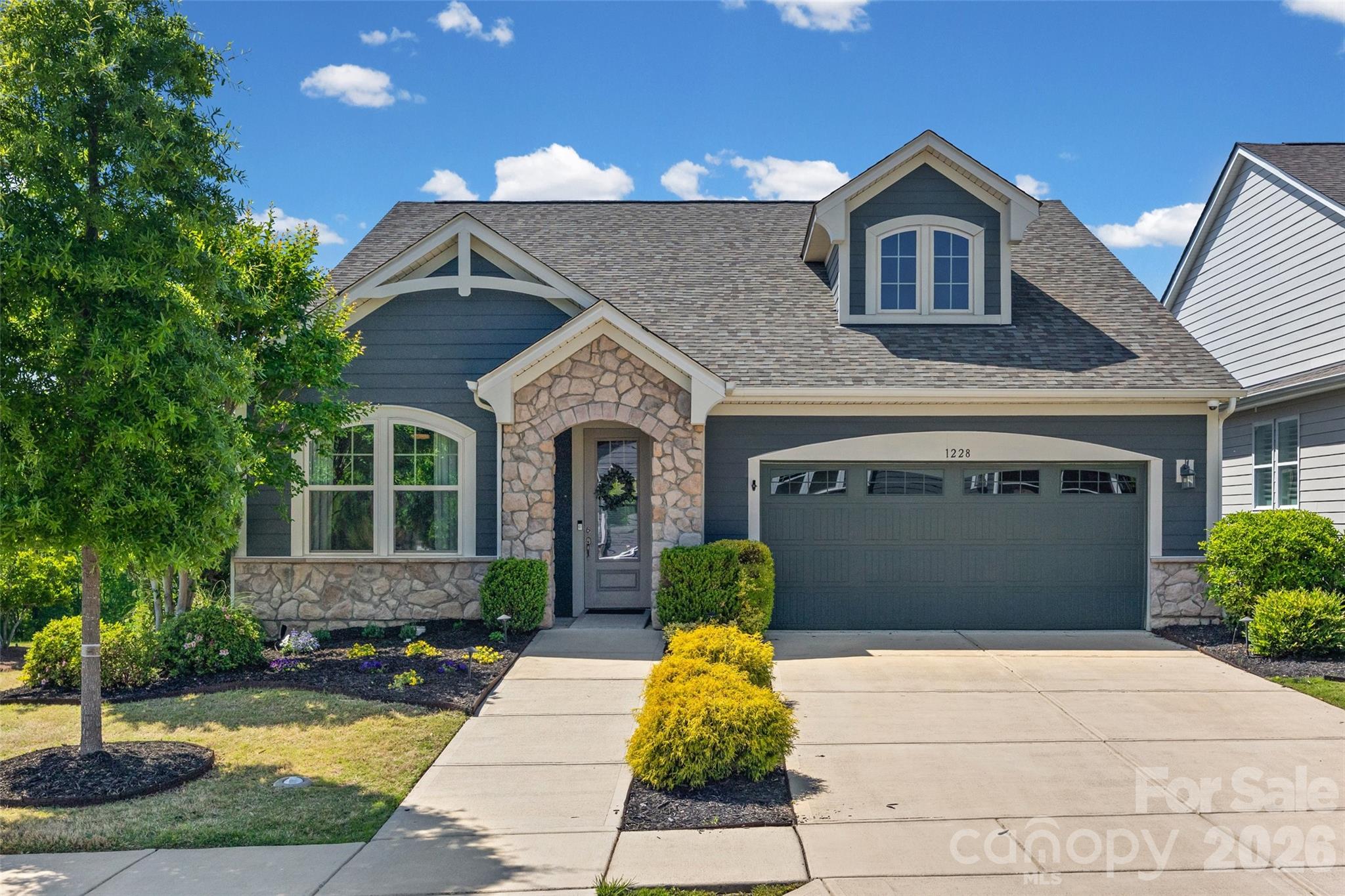 Beautiful Former Model Home in Cadence at Tega Cay! This stunning, thoughtfully designed home showcases high-end finishes and an open, inviting layout. The gourmet kitchen is a true showstopper—featuring granite countertops, a stylish backsplash, white cabinetry, KitchenAid appliances, a 5-burner gas cooktop, double ovens with built-in microwave and convection, and a large island perfect for entertaining. Rich hardwood floors extend throughout the main level, along with a well-appointed private office. The spacious primary suite offers a true retreat, featuring dual sinks, a zero-entry walk-in shower, and an oversized walk-in closet. Upstairs, you’ll find an additional bedroom with a full bath and a generously sized bonus room—ideal for guests, hobbies, or flexible living space. This home is equipped with a high-quality audio system with surround sound throughout the interior and covered porch, a high-end video security system, and high-speed internet. Enjoy the bright sunroom or relax on the covered porch, perfect for seamless indoor-outdoor living. Residents of Cadence enjoy an active lifestyle with a community pool, walking trails, and vibrant social opportunities. Ideally located near the upcoming Grove at Tega Cay, as well as shopping, dining, and convenient access to I-77.