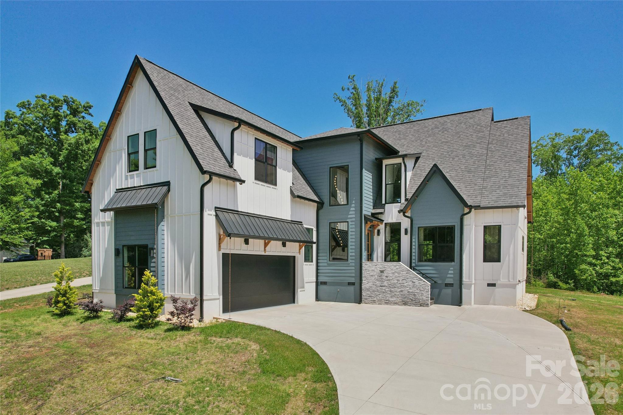 CUSTOM BUILT IN 2025 -- this gorgeous modern farmhouse 4 BR, 4 1/2 BA, 3600  HLA, sits on .91 acres and ROOM for a POOL.  Custom detail including accent lighting throughout, marble window sills, herringbone floor pattern, wide plank white oak eng. hardwood, modern finishes and 8' exterior/interior doors. The den features a fully retractable glass door system to expand the living space onto the covered porch. Open concept perfect for entertaining. The custom kitchen features tile backsplash, Quartz counter-tops, plentiful storage, built-in microwave & 60" side by side Euro style fridge/freezer. Center island features built in oven, dishwasher, cooktop w/range hood. A walk-in pantry w/ample storage, counter space & outlets. Every bath features Quartz counter tops, extensive flooring & wall tile. Two hot water heaters. Room for pool (not included). Two miles to 600 ACRE Mountain Creek Park offers mountain biking, walking trails, kayak/paddleboard launch, dog park, pickleball, picnic shelters, etc. 6 minutes from Villages at Sherrills Ford shopping (Publix, restaurants, medical, animal hospital/vet, Starbucks, Dunkin and more) and 5 minutes to Boat club, slip rentals and kayak rentals on Lake Norman.