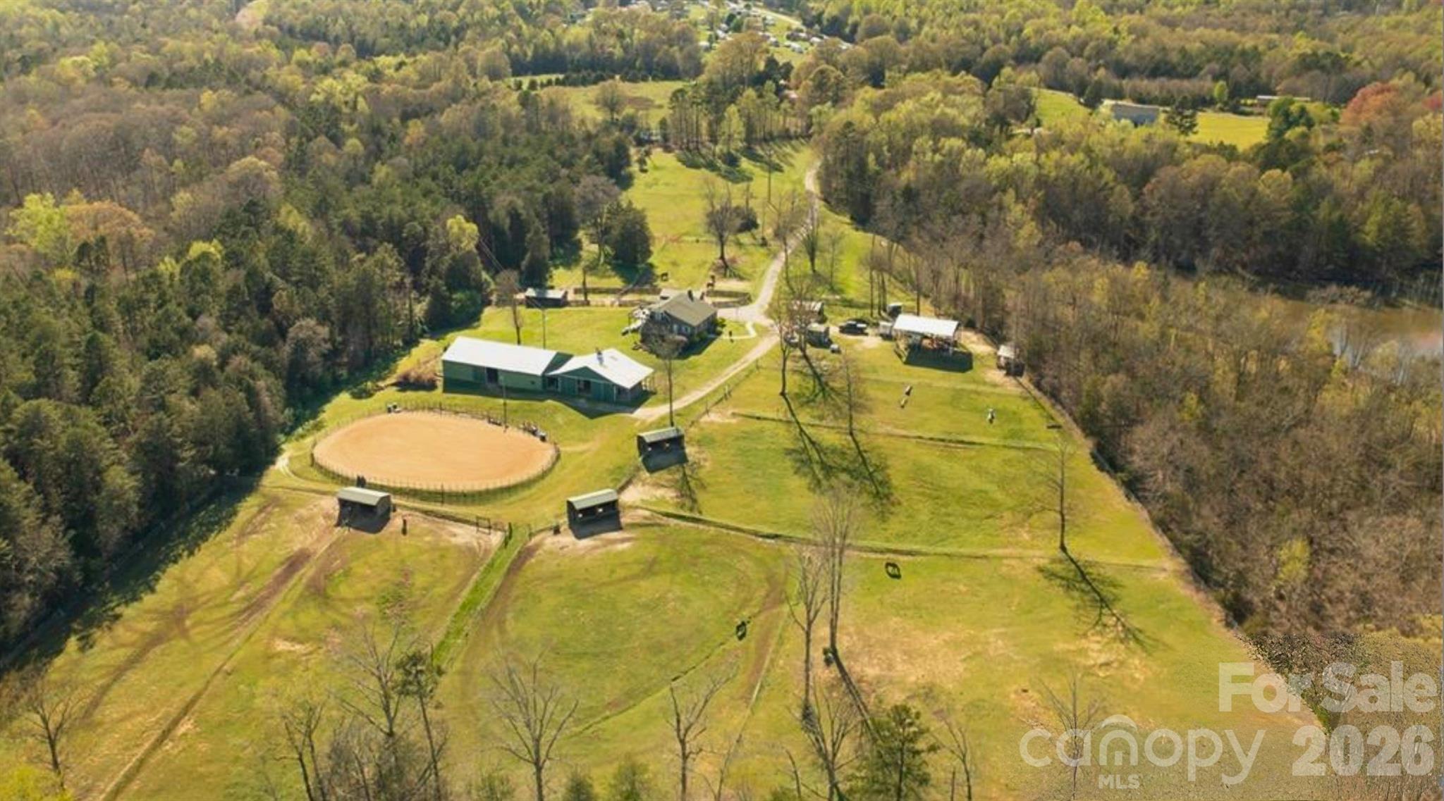 Rare opportunity to own a premier 12-acre equestrian property in the highly desirable Clover/Lake Wylie area! Conveniently located just minutes from Lake Wylie and an easy commute to Charlotte, this private horse farm offers endless possibilities for equestrian enthusiasts, hobby farmers, family compound or those seeking acreage close to modern conveniences.

The charming 5-bedroom, 3-bath home is full of character and ready for your personal updates and vision. A fully finished walk-out basement features a second kitchen, laundry area, and fireplace—ideal for multi-generational living, guest quarters, or additional entertaining space.
Designed with horses in mind, the property includes 10 stalls, a tack room, wash pit with hot water, hay storage, arena, and a smaller indoor riding area. Multiple fenced pastures each feature dedicated run-in sheds with water and power, and all rear pasture fencing has been recently replaced with electrobraid and new gates & posts. Additional improvements include an RV shed with dedicated power and 50-amp hookup, chicken coop, workshop/storage building, and a creek along the rear property line.
Enjoy the privacy and peaceful setting while being within walking distance of the popular Field Day Park sports complex. Acreage in this location is increasingly difficult to find, and the property is zoned for the new Lake Wylie High School. Whether you're looking for an established horse farm or a unique property with room to grow, this exceptional offering combines location, functionality, and opportunity.
(10) 12x12 stalls
(5) 25'x12' run in sheds with power and water in each
90'x145' arena
40' x30' RV shelter with dedicated meter, water and 50 amp hook up 
12'x'12' tack room with power and water
9'x36' stud run off barn
Trails around perimeter of property