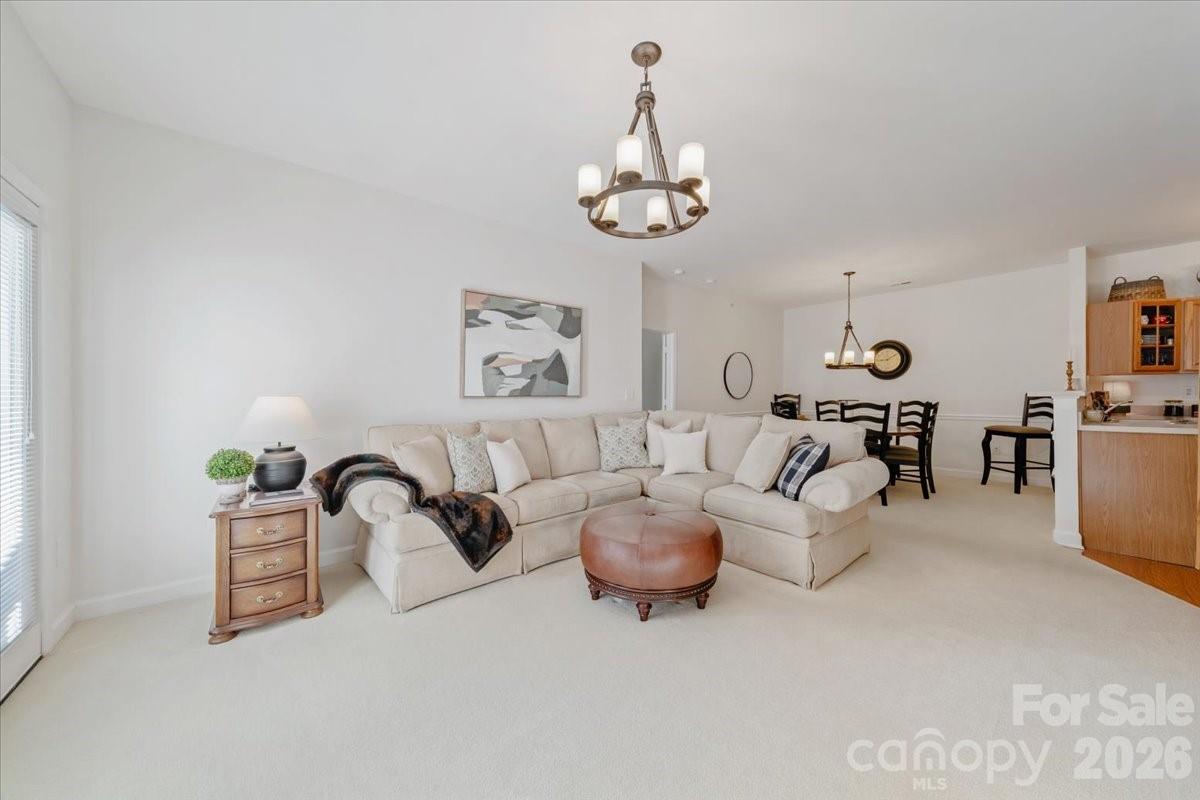 Nestled in the heart of Ballantyne, this sought-after main-level Copper Ridge condo is a true gem—no stairs, no hassle! Step into this immaculate 2-bedroom, 2-bathroom (split floor plan), where charm meets comfort and natural light pours into every corner.

The open floor plan invites you to relax in the cozy family room, complete with a fireplace & door  that lead to your own covered patio—perfect for morning coffee or evening unwinding. (additional storage as well with shelving) The spacious dining area flows seamlessly into the eat-in kitchen, featuring a breakfast bar that’s perfect for casual meals. The primary suite boasts a serene ambiance with a walk-in closet and en-suite bathroom, while the split floor plan offers privacy for the secondary bedroom—ideal as a guest room, home office, den or roommate. Plus, you’ll appreciate the convenience of an assigned parking space.

Living here means low-maintenance ease, with water, exterior upkeep, and trash removal included in the HOA. You’ll also enjoy an array of community amenities, from two swimming pools, tennis courts a fitness center, clubhouse, and picnic areas. The lighted streets and manicured common areas create a welcoming vibe, making this neighborhood a standout.

Convenience is key, and this location delivers! Just a short drive to Ballantyne Village & The Bowl- vibrant dining & shopping & coveted Ballantyne Spa. Whether you’re looking for relaxation, recreation, or easy access to everything you need, this condo checks all the boxes. Don’t miss out on this perfect Ballantyne lifestyle—schedule your visit today!

This unit is tucked away at the back of the developled which is perfect for low traffic and no cross through traffic.