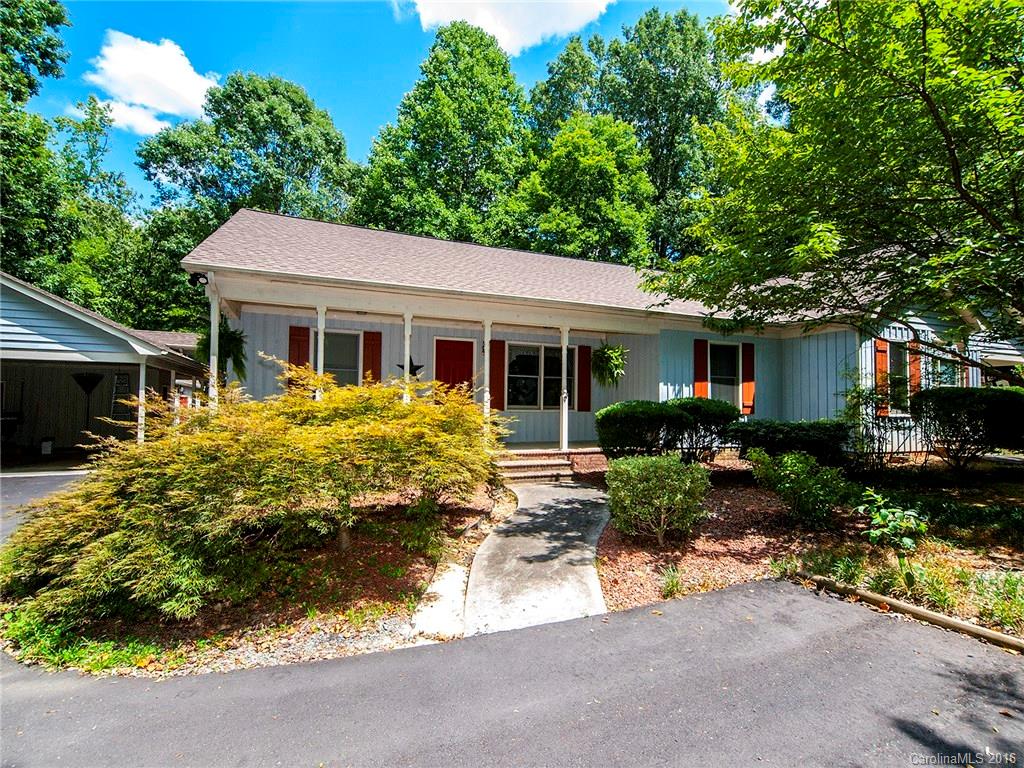 Very unusual duplex with 1/2 acre wooded, private lot.  There is a wonderful building that the current owner uses as a wood workship and storage.  This house has a split floor plan with tons of privacy for the master bedroom.  The master is complete with en suite and walk in closet.  The front porch is plenty spacious for rocking chairs.  The setting is wooded and idyllic.  Although this home is a duplex with Tons of privacy.  The open floor plan is spacious.  New sunroom.