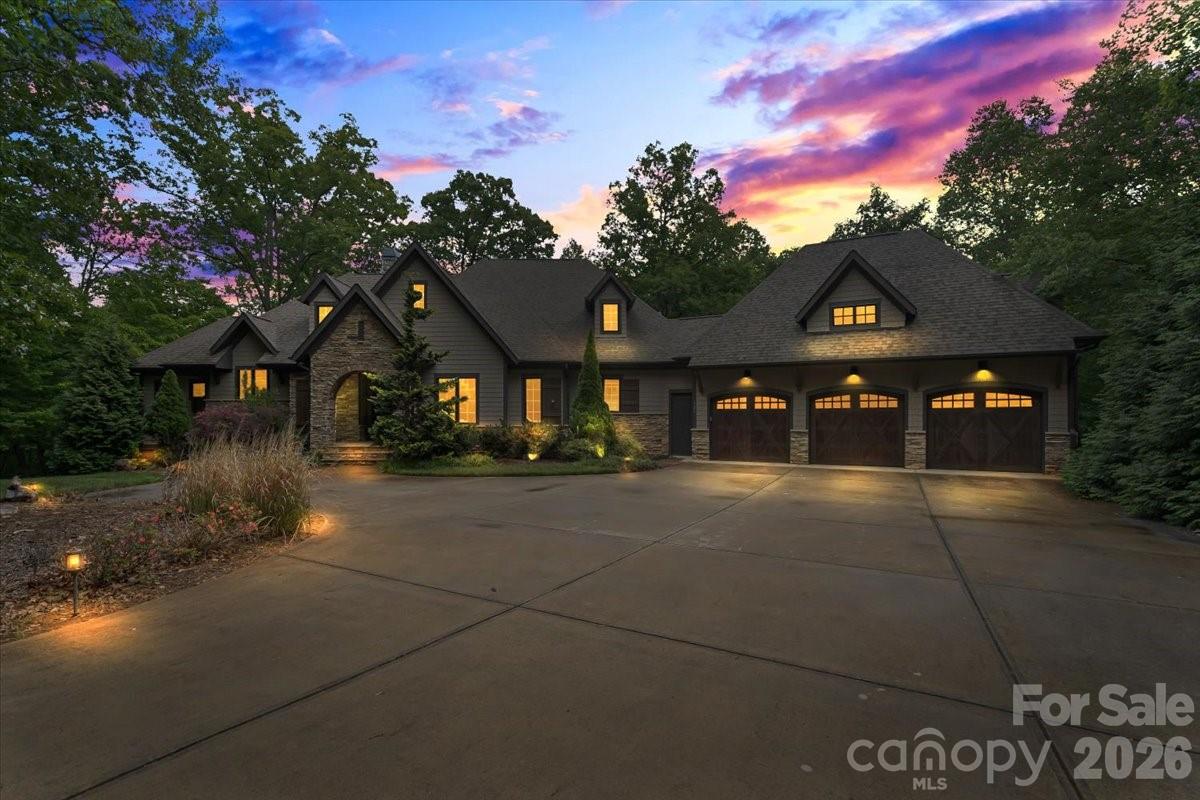 Tucked away on 3.47 private wooded acres in the heart of the Waxhaw-Weddington border, this one-of-a-kind estate delivers the ultimate blend of luxury, privacy, and lifestyle.

Set on a secluded flagpole lot and surrounded by luxury estates and horse farms, this residence has a gated entry and an impressive ~800-foot paved driveway that creates a grand sense of arrival, opening to a beautifully designed home surrounded by mature trees and natural serenity.

BRAND NEW luxury flooring has just been installed throughout the entire lower level, giving the home a fresh, modern look and feel.

Inside, soaring vaulted ceilings and expansive living spaces set the tone, with seamless indoor-outdoor flow designed for both everyday living and upscale entertaining. The main living area features a custom bar, while the chef’s kitchen is anchored by an oversized island and complemented by a stunning walk-in butler’s pantry with wood shelving.

The primary suite on the main level offers a true retreat, complete with a tray ceiling and tranquil wooded views.

Step outside to experience resort-style living, an expansive upper balcony, screened porch with outdoor grill and sink, and a second fireplace create the perfect setting for year-round entertaining. Unwind in the extra-large hot tub, perfectly positioned to take in the peaceful wooded backdrop. The backyard is a private oasis featuring a firepit, a putting green, and a fenced area, all surrounded by natural beauty.

The lower level is built for hosting, featuring a second kitchen/bar ideal for gatherings, game days, or multi-generational living.

Additional highlights include a spacious 3-car garage, extensive driveway parking, custom finishes throughout, and unmatched privacy just minutes from top-rated schools, shopping, and dining.

A rare opportunity to own a truly distinctive estate in one of Waxhaw’s most sought-after locations.