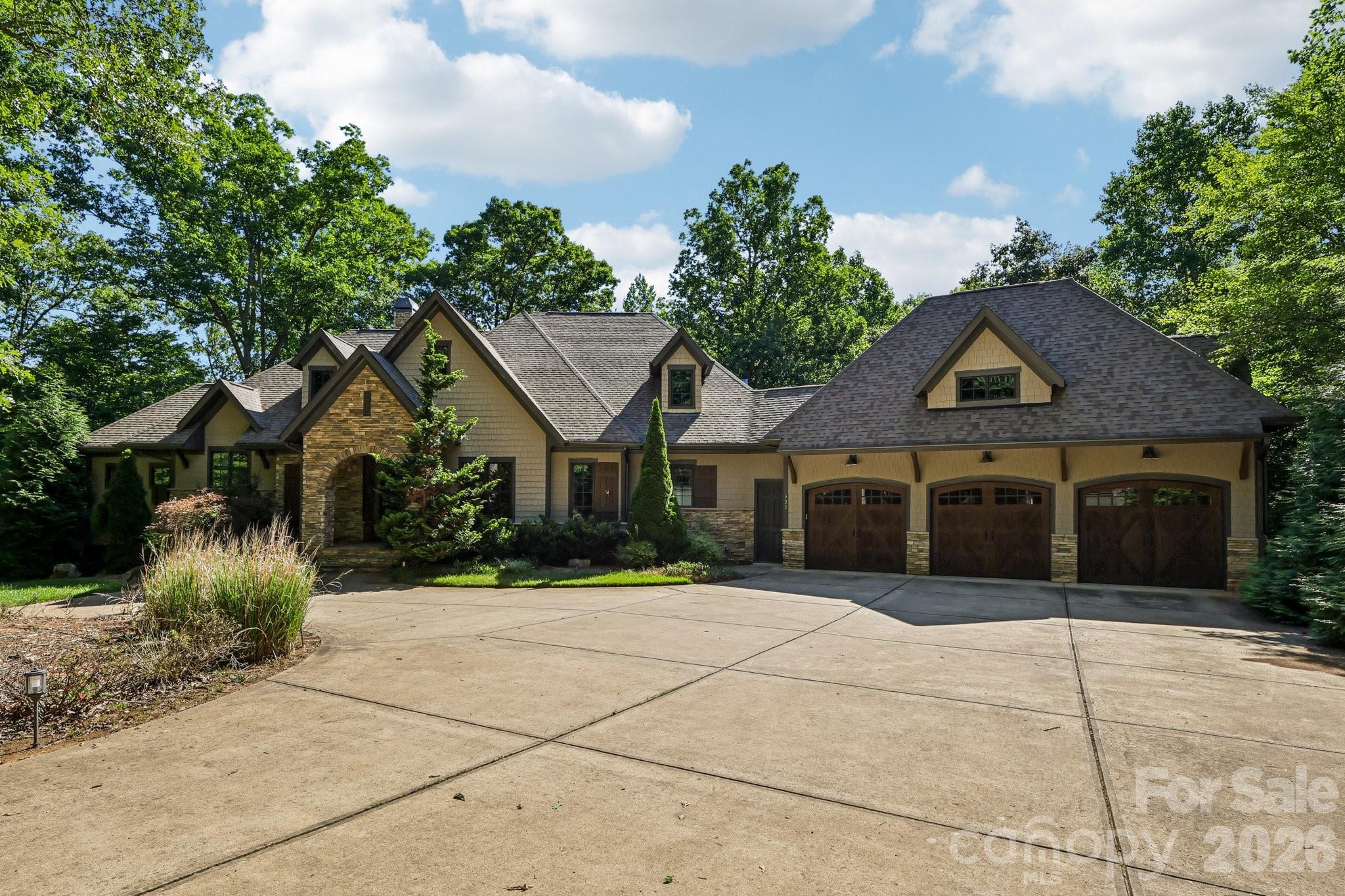 New Price Adjutstment! Tucked away on 3.47 private wooded acres in the heart of the Waxhaw-Weddington border, this one-of-a-kind estate delivers the ultimate blend of luxury, privacy, and lifestyle.

Set on a secluded flagpole lot and surrounded by luxury estates and horse farms, this residence has a gated entry and an impressive ~800-foot paved driveway that creates a grand sense of arrival, opening to a beautifully designed home surrounded by mature trees and natural serenity.

BRAND NEW luxury flooring has just been installed throughout the entire lower level, giving the home a fresh, modern look and feel.

Inside, soaring vaulted ceilings and expansive living spaces set the tone, with seamless indoor-outdoor flow designed for both everyday living and upscale entertaining. The main living area features a custom bar, while the chef’s kitchen is anchored by an oversized island and complemented by a stunning walk-in butler’s pantry with wood shelving.

The primary suite on the main level offers a true retreat, complete with a tray ceiling and tranquil wooded views.

Step outside to experience resort-style living, an expansive upper balcony, screened porch with outdoor grill and sink, and a second fireplace create the perfect setting for year-round entertaining. Unwind in the extra-large hot tub, perfectly positioned to take in the peaceful wooded backdrop. The backyard is a private oasis featuring a firepit, a putting green, and a fenced area, all surrounded by natural beauty.

The lower level is built for hosting, featuring a second kitchen/bar ideal for gatherings, game days, or multi-generational living.

Additional highlights include a spacious 3-car garage, extensive driveway parking, custom finishes throughout, and unmatched privacy just minutes from top-rated schools, shopping, and dining.

A rare opportunity to own a truly distinctive estate in one of Waxhaw’s most sought-after locations.