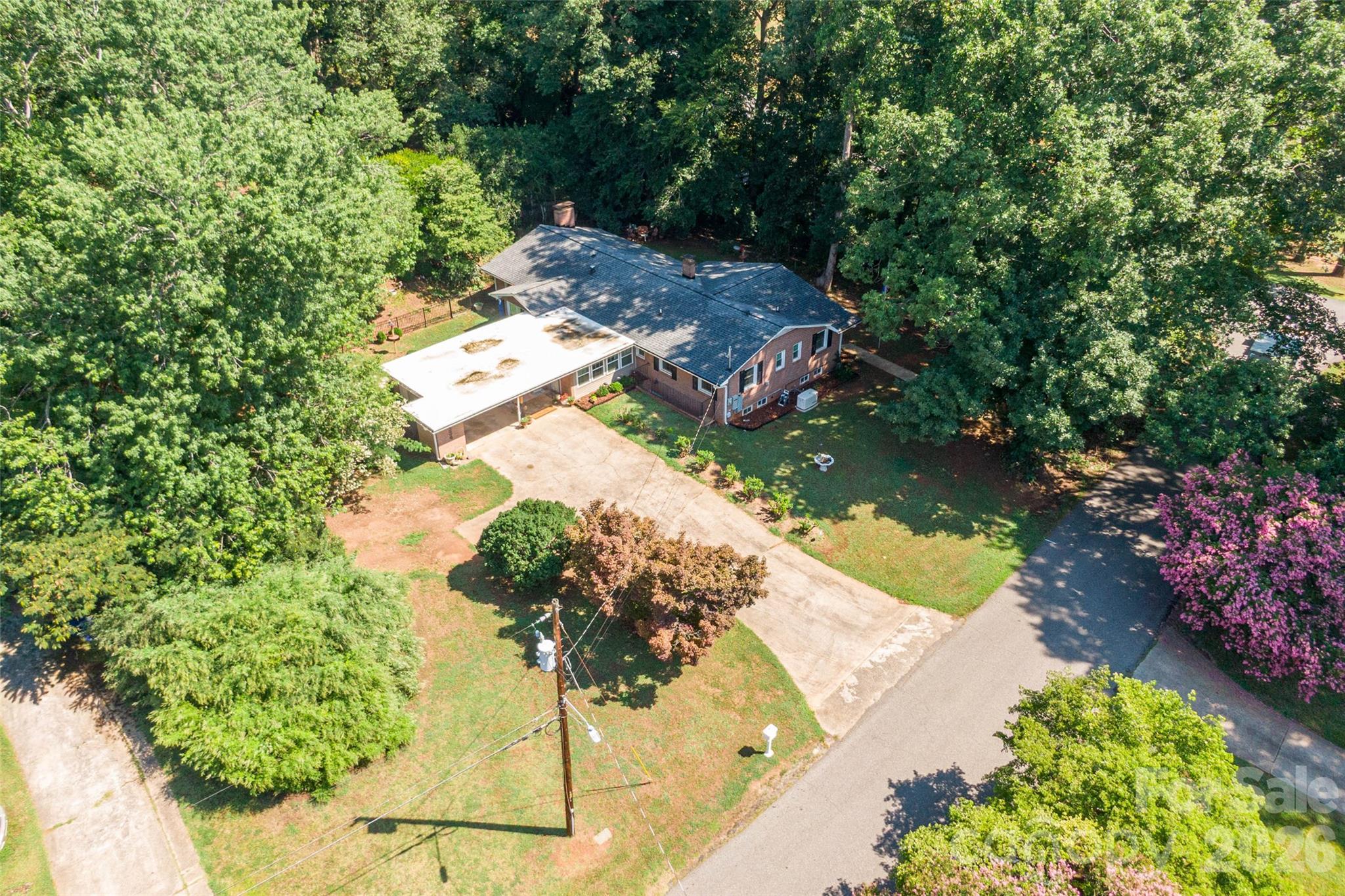Located in one of Shelby's most desirable neighborhoods, this move-in ready home is located across from the 12th hole of the Cleveland County Country Club! So many upgrades and additions have been made to this home with a detailed list in the document section. If you need flex space, check out the room you enter from the carport. This can be a family room, den, creative space. The french doors were specially ordered to contain a doggie door leading out to the patio area with a 10' patio umbrella housed in a partially fenced back yard. The open kitchen allows easy access to the breakfast nook, dining area and the gorgeous living room. The office space is conveniently located behind the kitchen space and on the other side of the windows in the flex space. Down the hall you will find the washer dryer and the three generously sized bedrooms, main bathroom and the primary bedroom with en suite. The basement has an additional office space or safe room, shower, a space for whatever you need. Enjoy the great outdoor living space whether it's in the backyard or on the spacious carport.