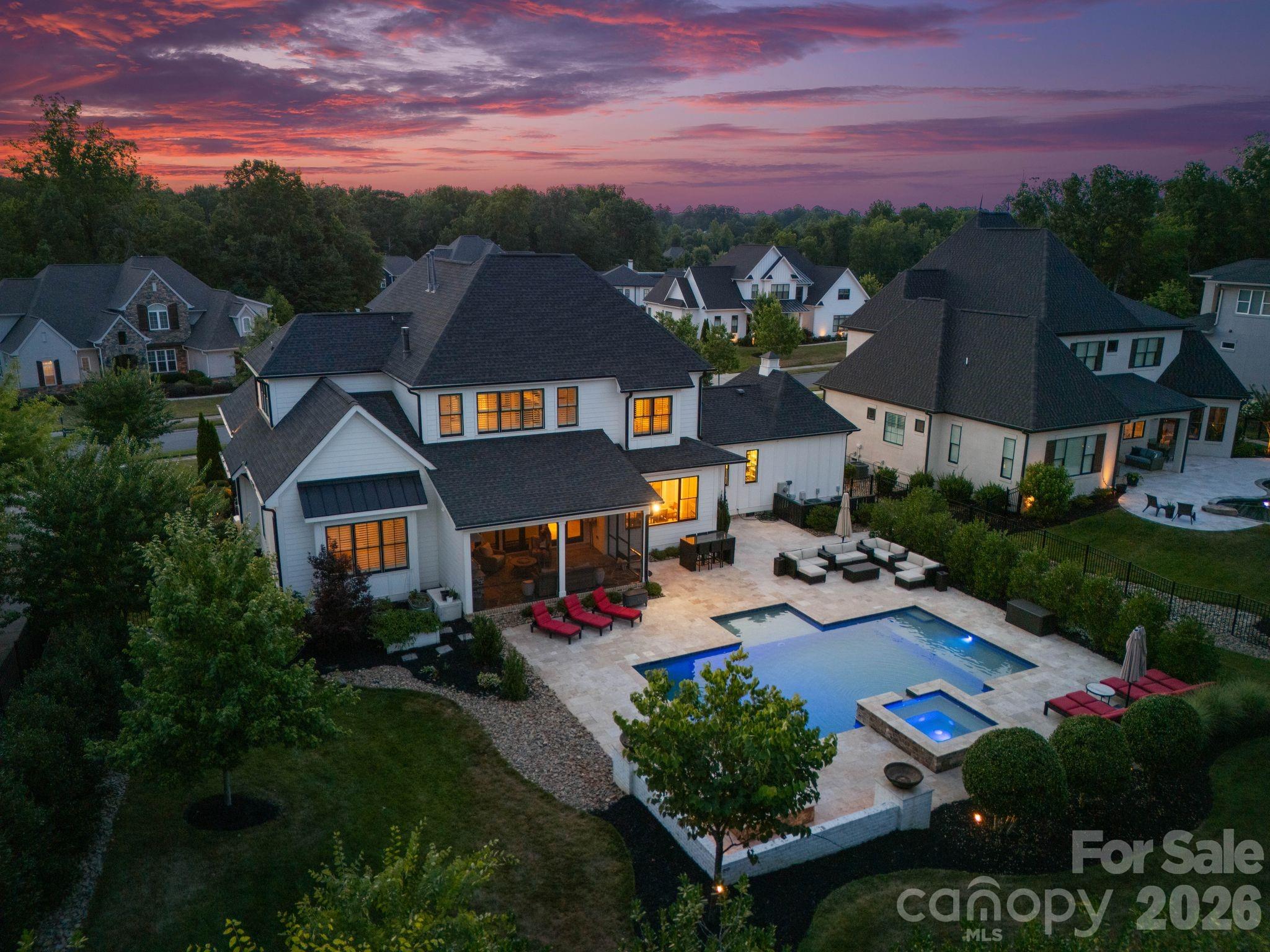 Welcome home to this stunning ES Johnson custom-built home situated on a desirable corner lot in The Reserve at River Run, one of Davidson’s most prestigious communities. Offering 5 bedrooms and 4.5 baths, this thoughtfully designed residence blends timeless craftsmanship with modern luxury and resort-style living.

Filled with natural light, the open floor plan seamlessly connects the kitchen, living room, and dry bar with custom built-ins — creating the perfect setting for everyday living and entertaining.

The spacious office is ideal for working from home and features beautiful custom built-ins, offering both functionality and style. The main-level primary suite serves as a private retreat with vaulted ceilings and a spa-like bath featuring a soaking tub and large walk-in shower.

Upstairs offers additional bedrooms along with a dedicated workout and sauna room. Step outside to enjoy the screened-in porch featuring a built-in grill with gas line, overlooking a resort-style pool and spa framed by beautiful travertine terraces — creating the perfect outdoor retreat for relaxing and entertaining year-round.

Additional highlights include exceptional storage throughout, a standing-height encapsulated crawlspace for superior storage, and an oversized 3-car garage featuring epoxy floors, custom storage, and EV charging. Ideally located just minutes from River Run Country Club, golf, dining, and all that Davidson has to offer, this home delivers a sophisticated lifestyle in one of the area’s most desirable communities.