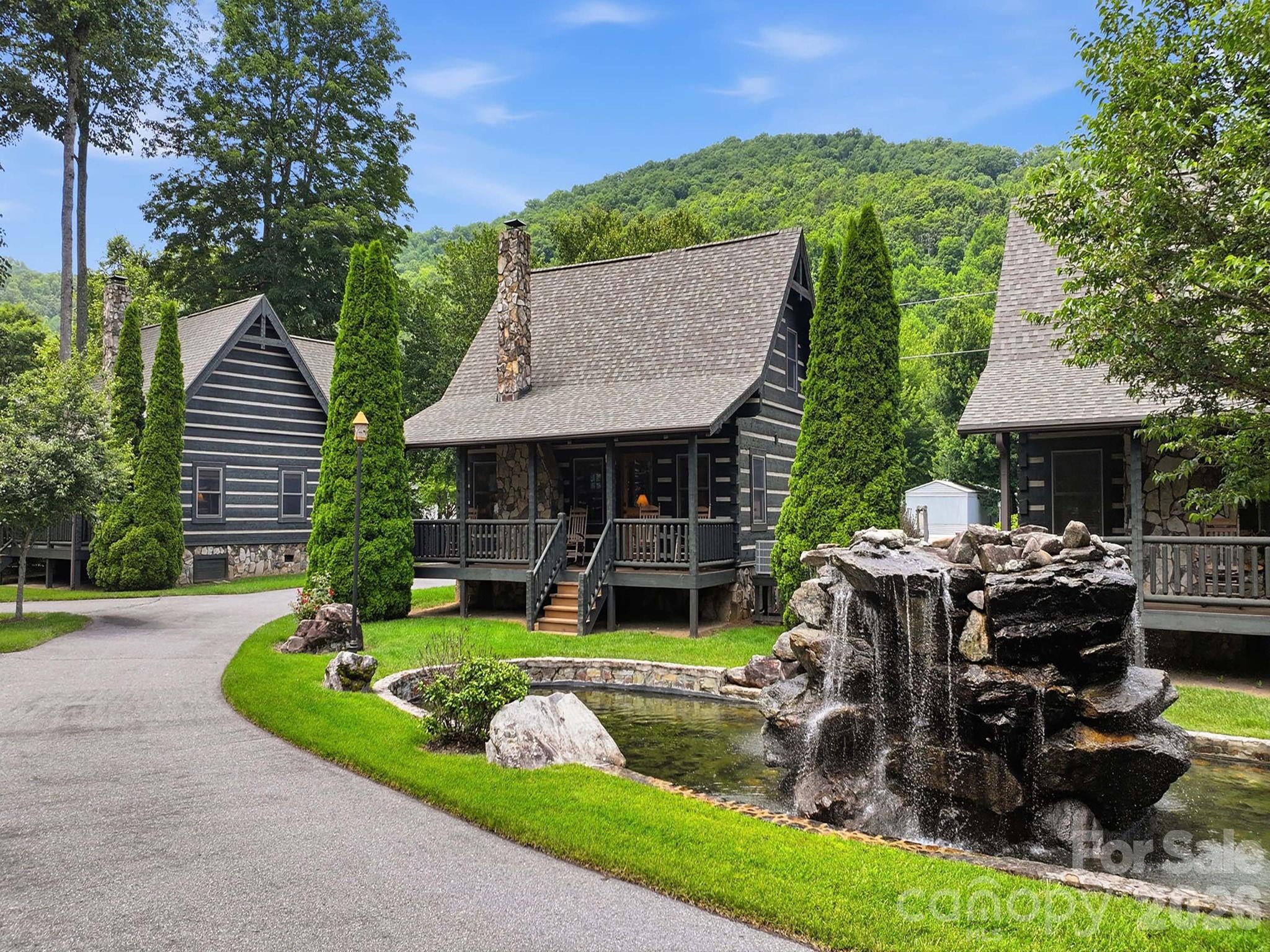 This two-bedroom, two full bath (with loft) was custom built by one of Western North Carolina's finest home builders, Scott Campbell.  Every detail of this authentic chink cabin has been thoughtfully curated.  Perched on the banks of Jonathan Creek in the Smoky Mountains of Maggie Valley, NC this could be your little slice of heaven. Sit on the porch and listen to the sounds of the creek or grab your fishing pole and try your luck at this famously stocked trout creek.  The community grill outside your door is perfect for gathering with friends and family while you enjoy grilling kabobs and taking a swim in the pristine mountain water.  This creek front dream getaway is being sold completely turnkey- sleeping six.  Pack your suitcase and come enjoy from day one.  The lock and go lifestyle is especially appealing as the HOA takes care of the landscaping allowing you to come and go freely without a care in the world.  Just a short golf cart ride to Maggie Valley Country Club- moments from award winning Downtown Waynesville voted #2 best downtown in America by USA Today.  40 Minutes to the Asheville Airport.  Located in valley- access is easy breezy- you and your guests will appreciate not having to take the switch back roads to a mountain top.  Maggie Valley appeals to year-round tourism with skiing in the winter, river rafting in the summer, horseback riding all year round.  Only 4 minutes to the Maggie Valley Fair Grounds where over 20 festivals are planned in 2026 alone- ranging from art and crafts to classic cars, bluegrass festivals, and more.  This is a solid investment any investor would appreciate!