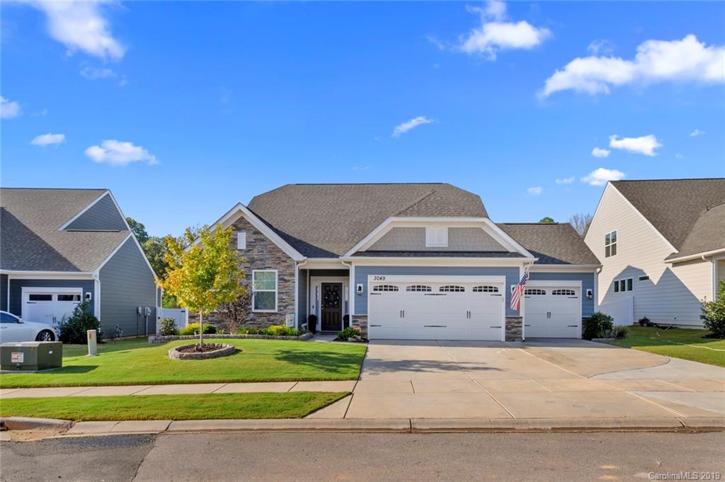 Welcome to this gorgeous 1.5 story home in Walnut Creek in the northern area of Lancaster, SC! Artfully upgraded with special features that include a 3 car garage, hardwood floors, upgraded light fixtures, crown molding, office, beams on the ceiling in the kitchen, a gas fireplace & an open floor plan with lots of natural light! The kitchen features granite counters, a center island, gourmet cabinets,  gas range, stainless steel appliances, and it flows into a large eating area and living room. Main Level owner's suite features a trey ceiling, ensuite bathroom with tiled glass shower, garden tub, dual sink vanity & walk in closet! An upstairs loft with a large bedroom, full bathroom and a huge bonus room that is perfect for entertaining. Plenty of storage with 2 large attic areas with door access. Enjoy time outside in the screened in porch, extended patio with fire pit or the beautifully landscaped fenced in backyard. You have direct access to the nature trail, via the backyard gate!