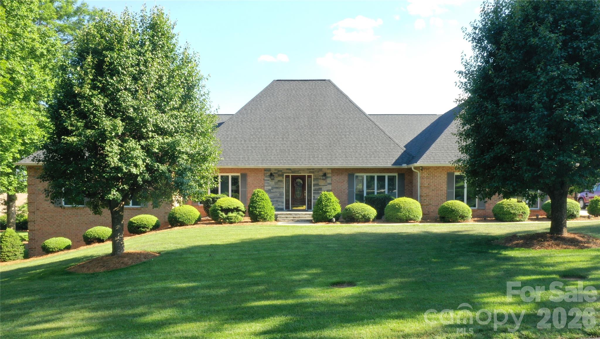 One-level living in the distinguished Rock Barn Golf and Spa community! Meticulously maintained and turnkey ready! Situated on a quiet street, this custom all brick home features timeless design and a thoughtful floor plan. The home offers four large bedrooms/sleeping rooms, two and a half bathrooms, and spacious living areas spanning across 3,361 square feet all on one level. Highlights include a luxurious primary suite complete with a fully updated ensuite bathroom and a gorgeous kitchen with ample storage, complemented by a breakfast area, butler’s pantry and an elegant formal dining room. Just steps off the kitchen area is an expansive outdoor deck that overlooks the private lot. In addition, the home boasts a partially finished basement spanning 2,283 square feet with a walkout patio, presenting endless opportunities. A second septic tank is in place, providing build opportunity to support additional bathrooms. The Rock Barn clubhouse is just a short walk or golf cart ride away, and membership to the country club is attainable. Membership includes access to 36 holes of championship golf including the famed Robert Trent Jones Jr. designed private course and the tranquil European day spa, Olympic-size pool, tennis and pickleball complex, fitness center, and casual and formal dining options. The Rock Barn community is easily accessible from Interstate 40 and NC Highway 16 and is conveniently situated less than an hour away from Charlotte, Winston-Salem, and Boone, NC, and just 15 minutes from downtown Hickory, NC. Contact Rock Barn directly for membership pricing information.