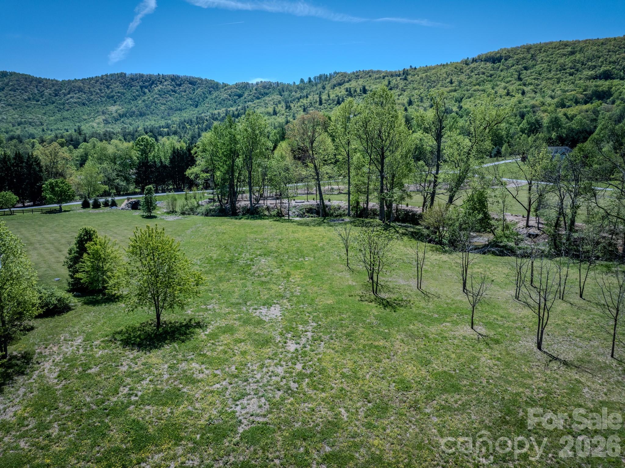 Lot 5 in Red Maple Farms is a unique 1.5-acre property located between Hendersonville and Brevard. Perfect for a builder! It’s just 7 minutes from Jeter Mountain Farm, 10 minutes from DuPont State Forest, 20 minutes from the entrance to Pisgah National Forest, and 30 minutes from Asheville Regional Airport. The southern boundary includes more than 400 feet of year-round waterfront along Mud Creek, and access is easy via the private paved road, Walnut Valley Lane, directly off Walnut Cove Road.

The lot is cleared and ready for your build, offering wide, year-round mountain views from nearly every point. Not to mention, it has over a dozen fruit-bearing walnut trees on the property! Power and wired AT&T internet are already available at the property; a well, septic system, and propane will need to be installed. While the property is part of a planned community, there is no active HOA.

Call today for more information or to schedule your showing!