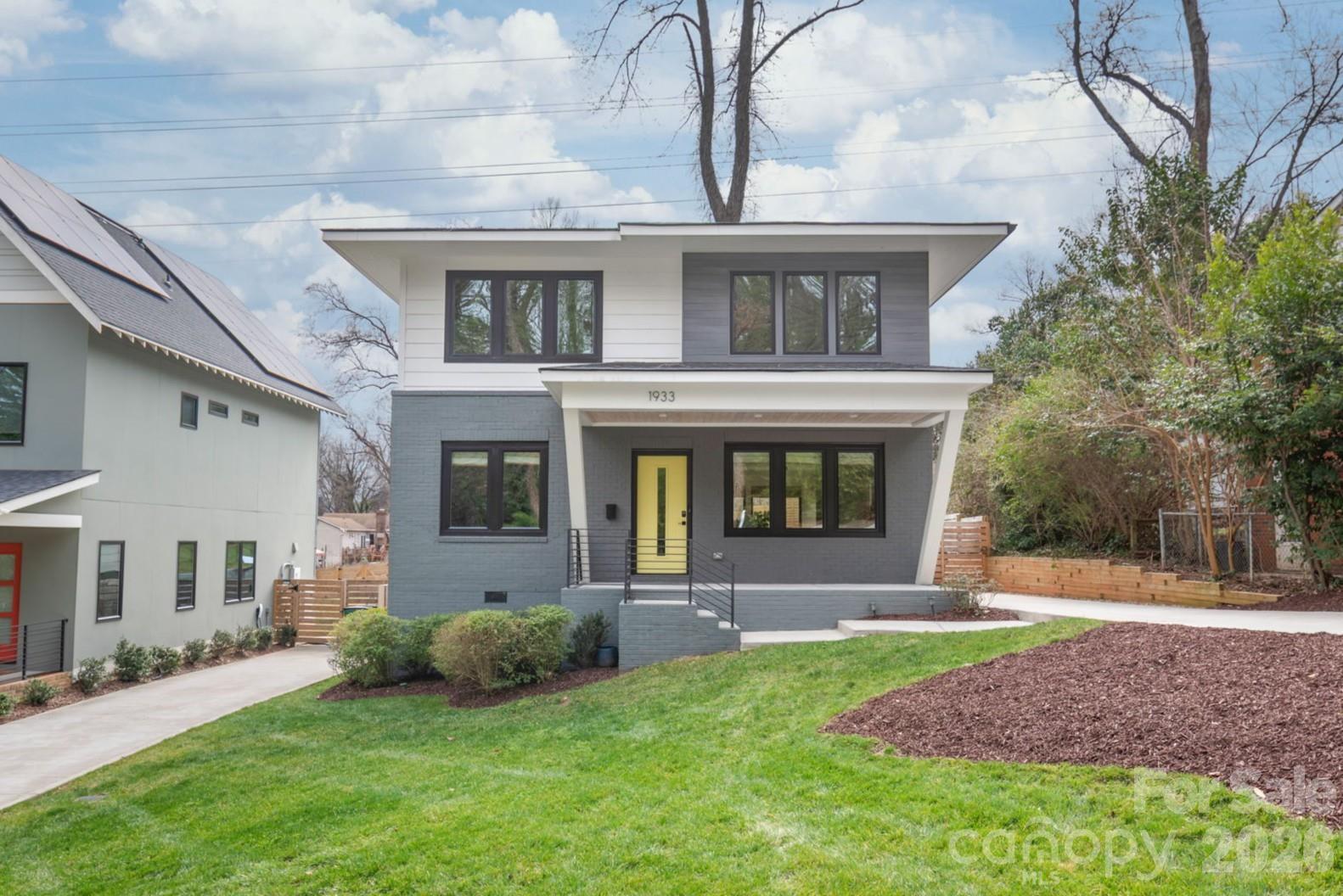 Welcome to 1933 St Paul in the heart of the rapidly growing Lincoln Heights community in Charlotte. Built in 2022, this 4-bedroom, 2.5-bath home offers approximately 2,100 square feet of thoughtfully designed living space with a striking modern front elevation and contemporary finishes throughout. Inside, you’ll find site finished hardwood floors flowing seamlessly across the entire home, complemented by tile flooring in all bathrooms. The open-concept main level is anchored by a beautifully connected kitchen, dining, and living area perfect for entertaining or everyday living. Incredible natural light fills the space, highlighting clean lines and elevated design details. The main level features a spacious primary suite offering comfort and privacy, along with a versatile fourth bedroom ideal for a home office. Upstairs, a generous loft provides flexible living space, accompanied by two additional bedrooms, a full bath, and a dedicated gym area. Situated at the end of a quiet dead-end street, this property offers exceptional privacy and a large, usable backyard with plenty of room to relax, play, or entertain. From the rear second floor windows, enjoy select views of Uptown, adding a subtle urban backdrop to this peaceful setting. Conveniently located with quick access to I-77 and Uptown, this home blends modern design, functional layout, and prime location into one exceptional opportunity.