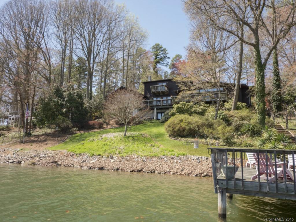 Totally remodeled & expanded cottage, within skiing distance of Lake Norman State Park. Expansive views w/deep water. Extraordinary kitchen/dining area was the former cottage, which was torn down to studs. The upper br's & garage was another addition; new master suite added even later. Grandfathered pier (refurbished) - more sq ft than now allowed, w/large sitting area & covered boat slip. Lush landscaping. Huge storage room in bsmt. Lower level finished - propane stove installed in fp; no AC.