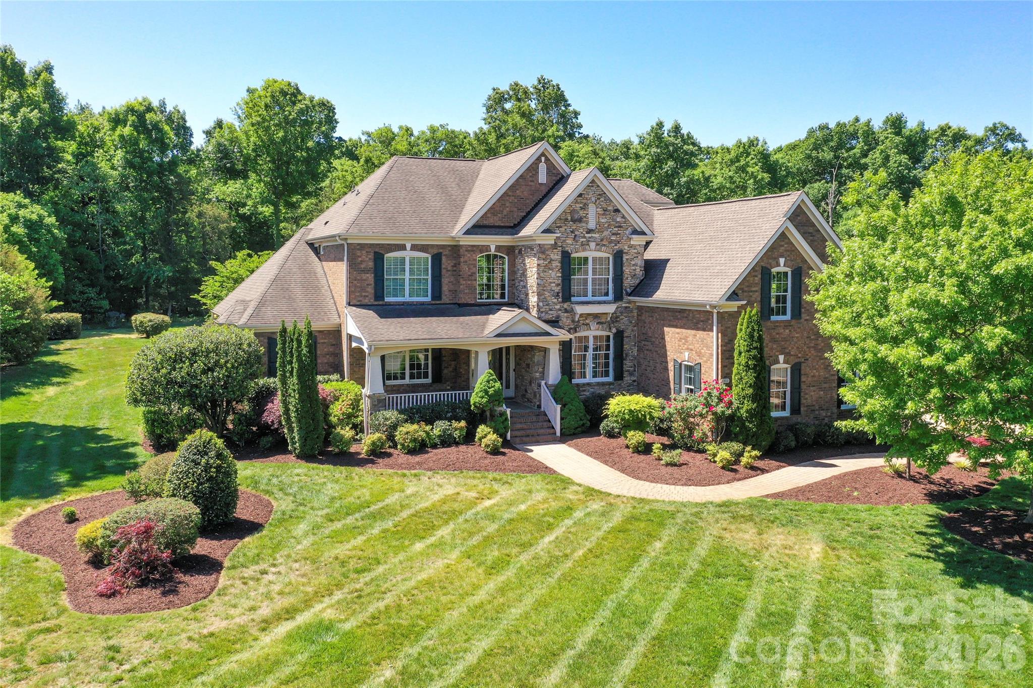 Beautiful former model home located in the estate section of Marvin Creek with over 7,500 square feet of thoughtfully updated living space walking distance to a world class amenity center, walking trails, parks, and green space. Home has a two-story foyer and great room, large dining room and separate office area, updated kitchen with new appliances (2026) that leads to a large morning room with abundant natural light. Generously sized primary suite on main—providing both comfort and convenience with a fireplace and large dedicated sitting area. Upstairs find 4 bedrooms two connected by Jack/Jill Bath and one with ensuite bath, a large flex space, and a bonus room. Basement has a large media room, great for movie nights or game days, a full bath and wine cellar and an enormous recreation area. Step outside to a private, wooded backyard retreat featuring a large patio area, built-in fire pit, and gas grill—ideal for entertaining. A welcoming front porch adds to the home’s charm and curb appeal. This home has been freshly painted inside, has new carpeting throughout, updated lighting, a dedicated well for irrigation and is located just minutes from shopping, schools and entertainment. An exceptional opportunity to own a luxury home in one of Marvin’s premier communities.