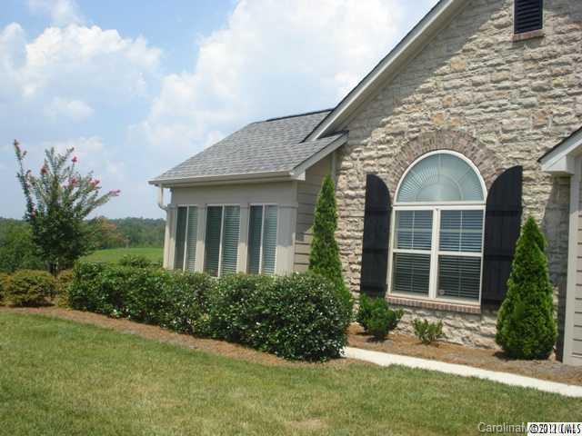 The one level home has an amazing view of the rolling hills of Tega Cay. Solar lit kitchen features dozens of cabinets and amazing storage. Solid surface countertops and a butlers pantry as well. Office could be used as a third bedroom. Relax at the end of the day and enjoy the beautiful view from the patio.