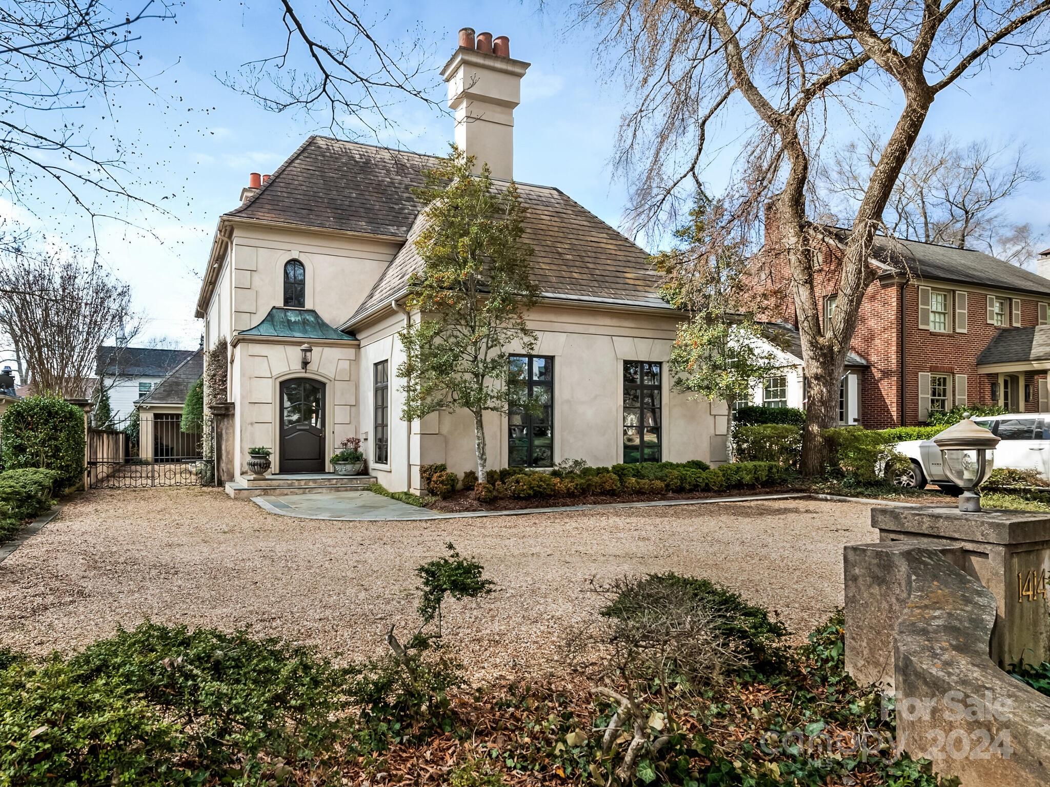 One of a kind home located in the heart of Eastover. This beautiful hard coat stucco home was built by Phillip Thomas. The elegant blend of French Architecture includes a grand two story foyer with marble, curved staircase, 12 ft ceilings, custom moldings/trim, & hardwood flooring, floor to ceiling windows, 4 fireplaces & 4 sets of french doors lead you to the covered porch & backyard. French doors also lead you to a cozy pine library w/ handsome millwork, custom bookshelves, large fireplace, & wet bar make this room perfect for relaxing. Cooks kitchen overlooks the backyard features functional custom cabinetry, 6 gas burner stove, Wolf double oven, microwave & Sub-Zero refrigerator. Additional special feature to this home include a Wine room, a room above the carport that can be an office/ playroom & third floor of this house could be a fourth bedroom and bathroom! The primary suite is on the second floor that has french doors that lead to balcony overlooking the yard!