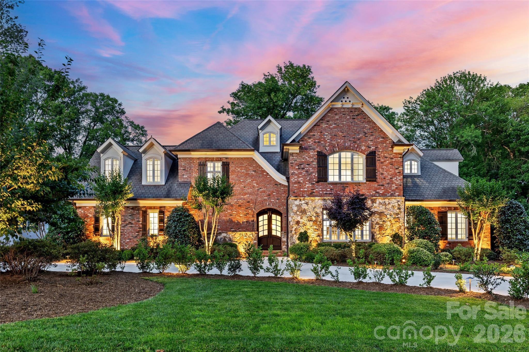 Beautiful move in ready Olde Cotswold home nestled on a picturesque street in one of Charlotte’s most coveted neighborhoods. This exceptional residence offers over 6,200 square feet of refined living, thoughtfully designed for both entertaining and everyday living. Custom built in 2007 by Kelly McArdle this home includes thoughtful architectural details and custom molding at every turn and is sure to impress. From the moment you enter, you are greeted by soaring 10-foot ceilings and an effortless flow throughout the main level. Beautifully appointed dining room with gas fireplace and large windows. The expansive kitchen features painted inset cabinetry, new quartz countertops and wrapped backsplash, under cabinet lighting, Thermador double oven, warming drawer and gas cooktop with hood and pot filler, island and peninsula with sink and room for barstool seating open to a generous breakfast area. The amazing bar area is equipped with beverage refrigerator, ice maker and sink with great storage and built-in cabinetry, gas fireplace and dedicated wine room.  An inviting living room with gas log fireplace - filled with expansive windows and natural light with two french doors leading to covered rear patio - the seamless transition creates an elevated indoor/outdoor experience. Primary suite on the main floor is a private retreat with walk-in closet and spacious bath including dual separate vanities, soaker tub and tile surround shower. The main level is complemented by an additional guest suite with en suite bath and tucked away private office with French doors overlooking front yard. The upper level continues to impress with spacious bedrooms, three full bathrooms, a large bonus room with full refrigerator and sink area, recreation room and versatile flex spaces—ideal for a media lounge, fitness studio or second office. Stunning, flat and private 0.49 acre lot. Incredible outdoor covered living area with fireplace, outdoor TV, built-in gas grill and expansive rear fenced yard. Additional features include dual laundry - up and down, a substantial three-car garage with motor court, back staircase and abundant storage solutions integrated throughout the home. Home has generator. Located in the highly desirable Cotswold area and conveniently located to Southpark and Uptown. This is one not to miss!