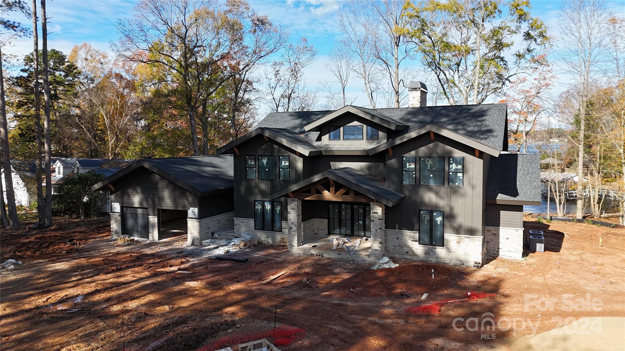 Experience unparalleled elegance in this stunning luxury lake home featuring an open floor plan that perfectly blends style and functionality.  1st level primary suite, offers a tranquil escape with an oversized shower, closet, and laundry area. The heart of the home boasts cathedral ceilings in the great room, 10’ ceilings on main level with 8' doors.  The custom-designed kitchen is a chef’s dream, 48” free-standing dual-fuel smart range with six sealed burners, double oven&under-counter microwave drawer, a quiet dishwasher, and a built-in side-by-side refrigerator/freezer, pantry with wine refrigerator. Highlights include black-on-black windows, quartz countertops. Upstairs features 3 Bedrooms/3Baths and loft. The oversized two-car garage leads to a pool house, and 1 of the outside to the covered living areas, complete with an outdoor kitchen—perfect for dining while overlooking the lake making this property a true oasis for relaxation and entertainment. Lot can accommodate a pool.